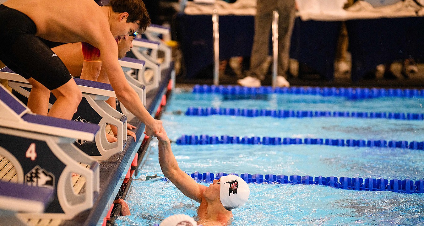 Nathanael Van Liew and Parker Dangleis celebrate Whitworth's winning 400 medley relay at NWC Championships 2025-26