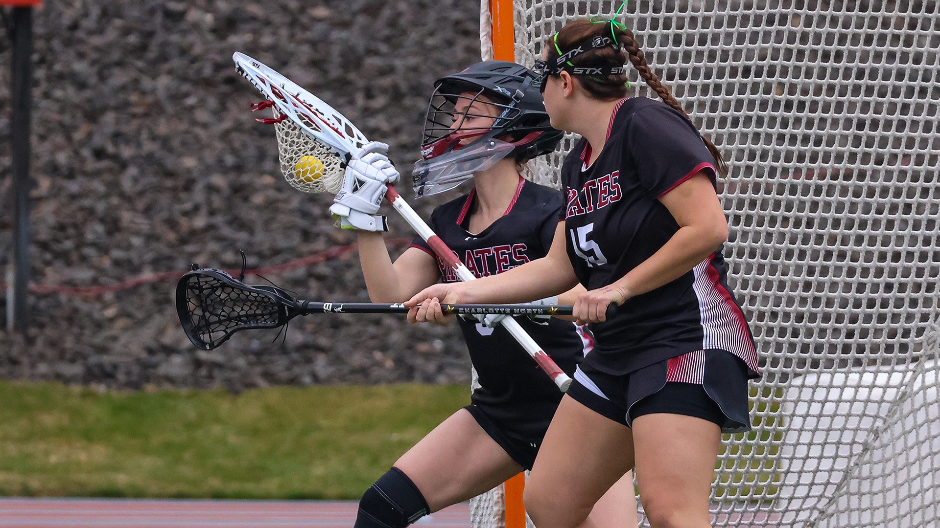 Kayla Jones makes a save as Mary Penfield looks on vs. Kalamazoo 2026