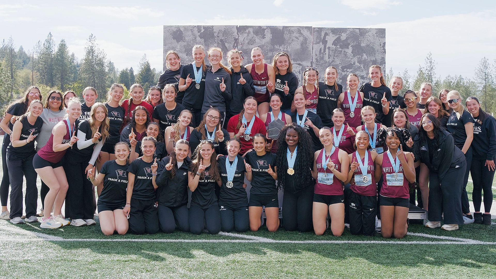 Whitworth women celebrate with the trophy for winning the 2026 T&F Championship