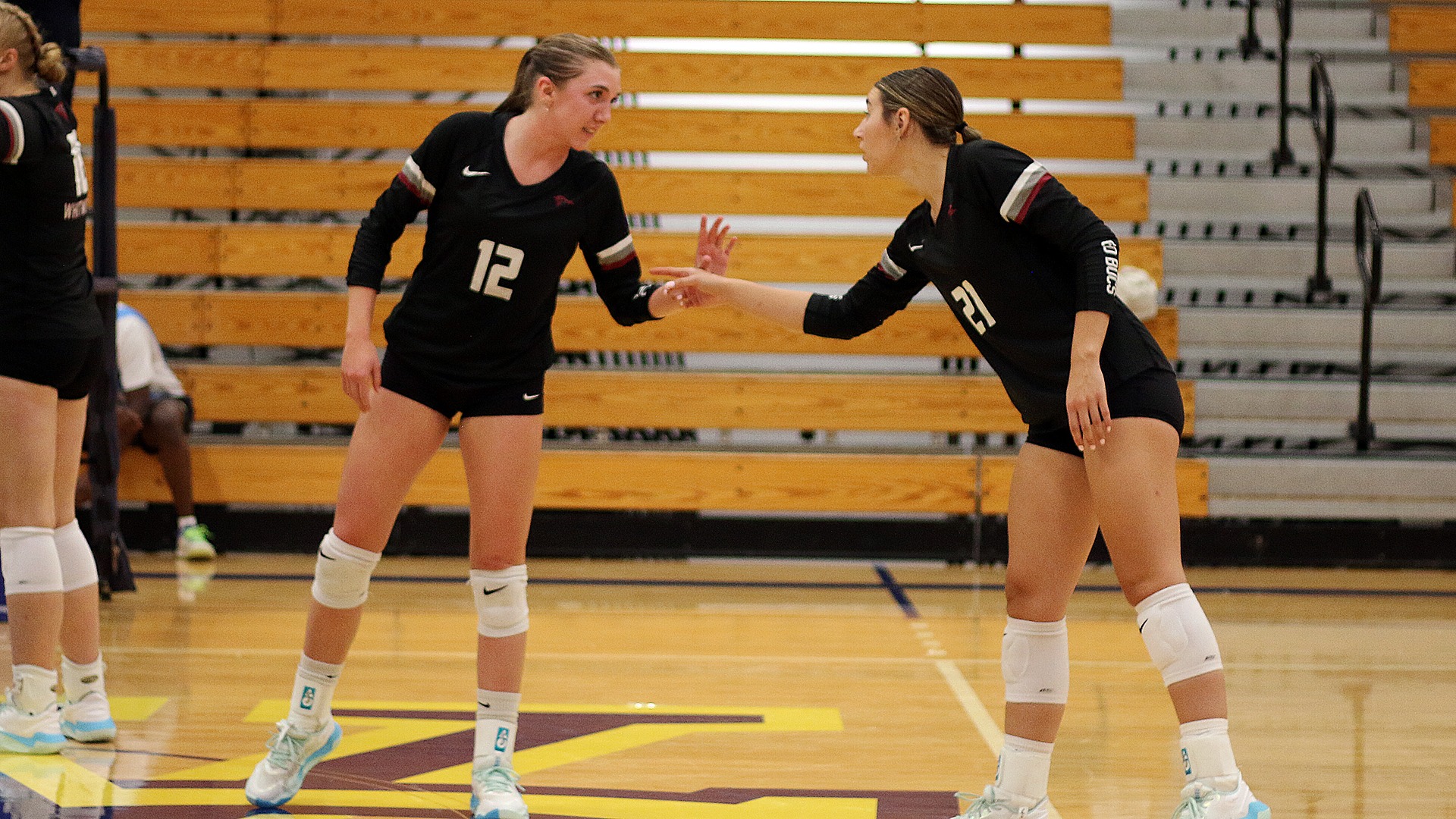 Bryanna Dodson and Hailee Biegler confer before serve vs. Wis.-Stout 2026