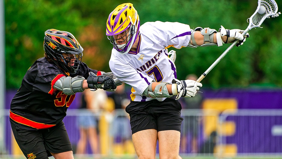 Laurier Men's Lacrosse player defended by opponent from the University of Guelph.