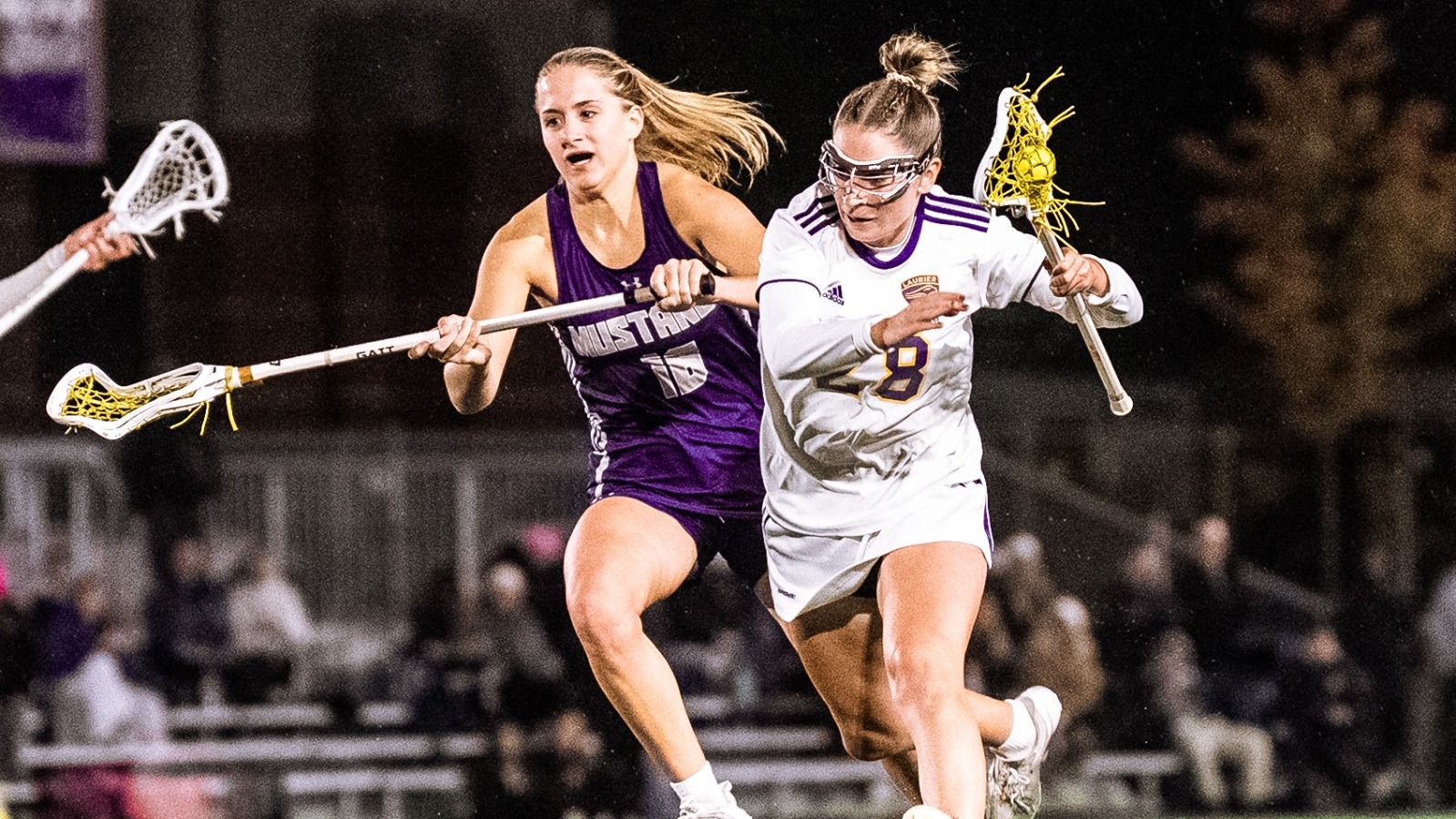 Laurier women's lacrosse moves the ball up the field against Western.