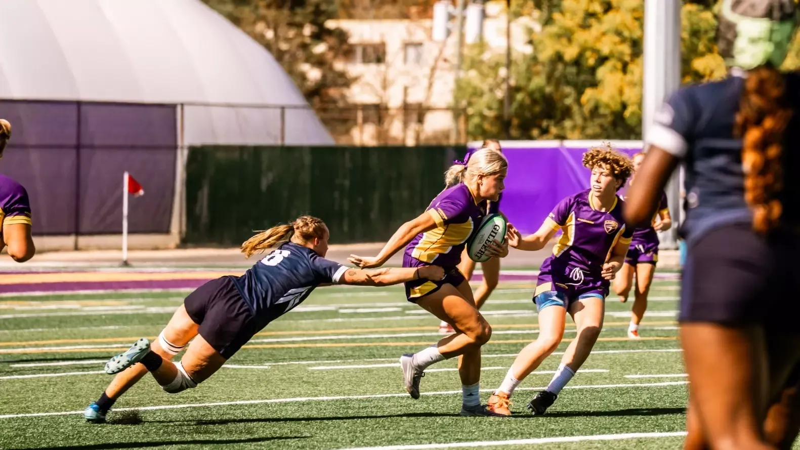 Laurier brushes away a potential Toronto tackler.