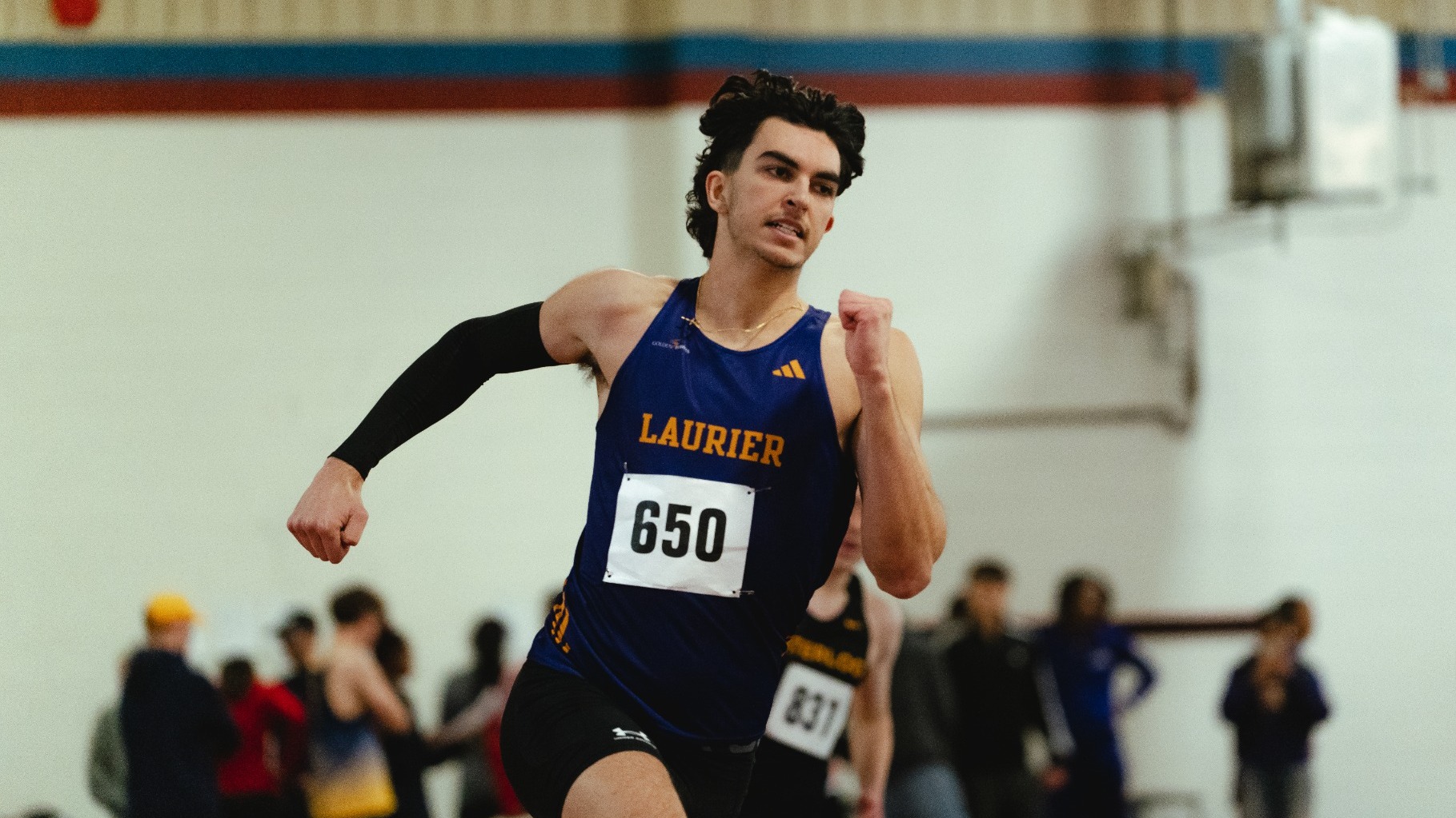 A Laurier middle distance runner sprints in a race.