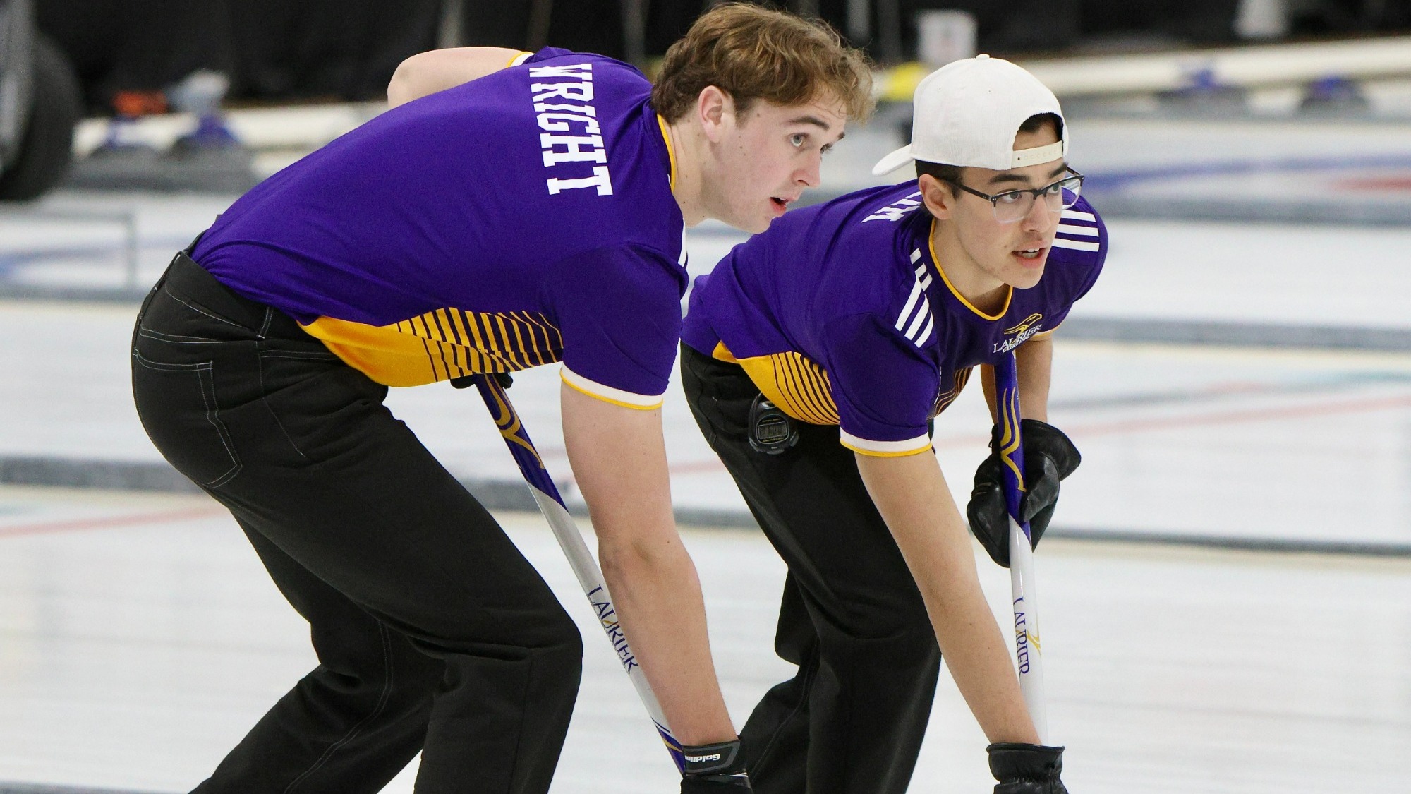 Wyatt Wright and Nathan Kim sweep a shot down the ice.