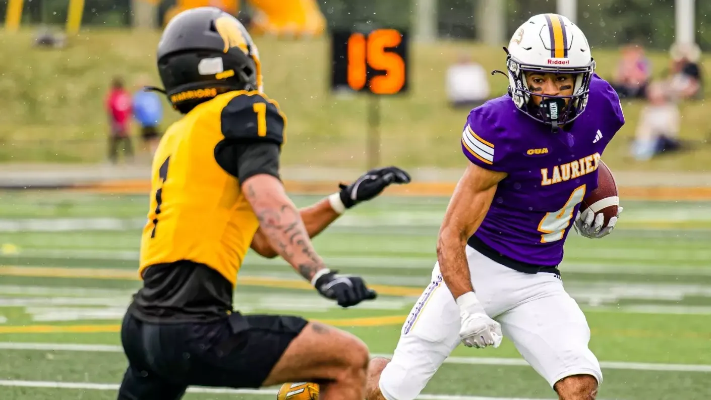 Ethan Jordan looks downfield against a Waterloo defensive back.