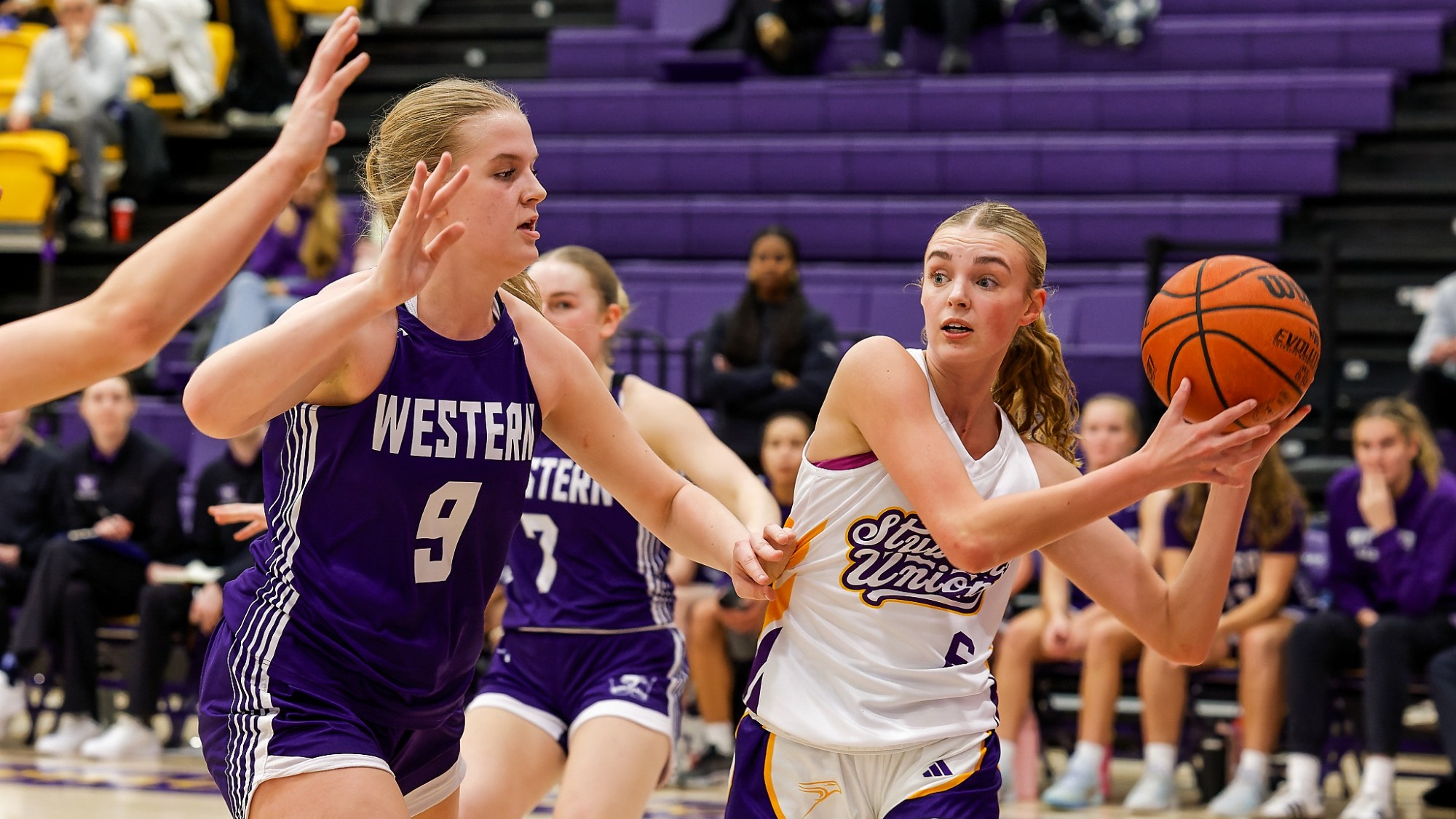 A Laurier women's basketball player tries to pass through the Western defence.