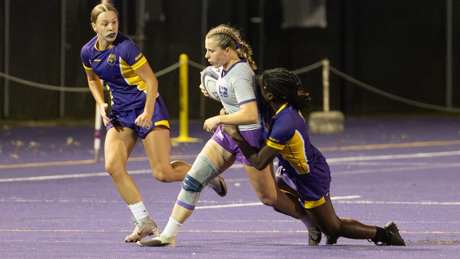 Laurier women's rugby making a tackle against Western.