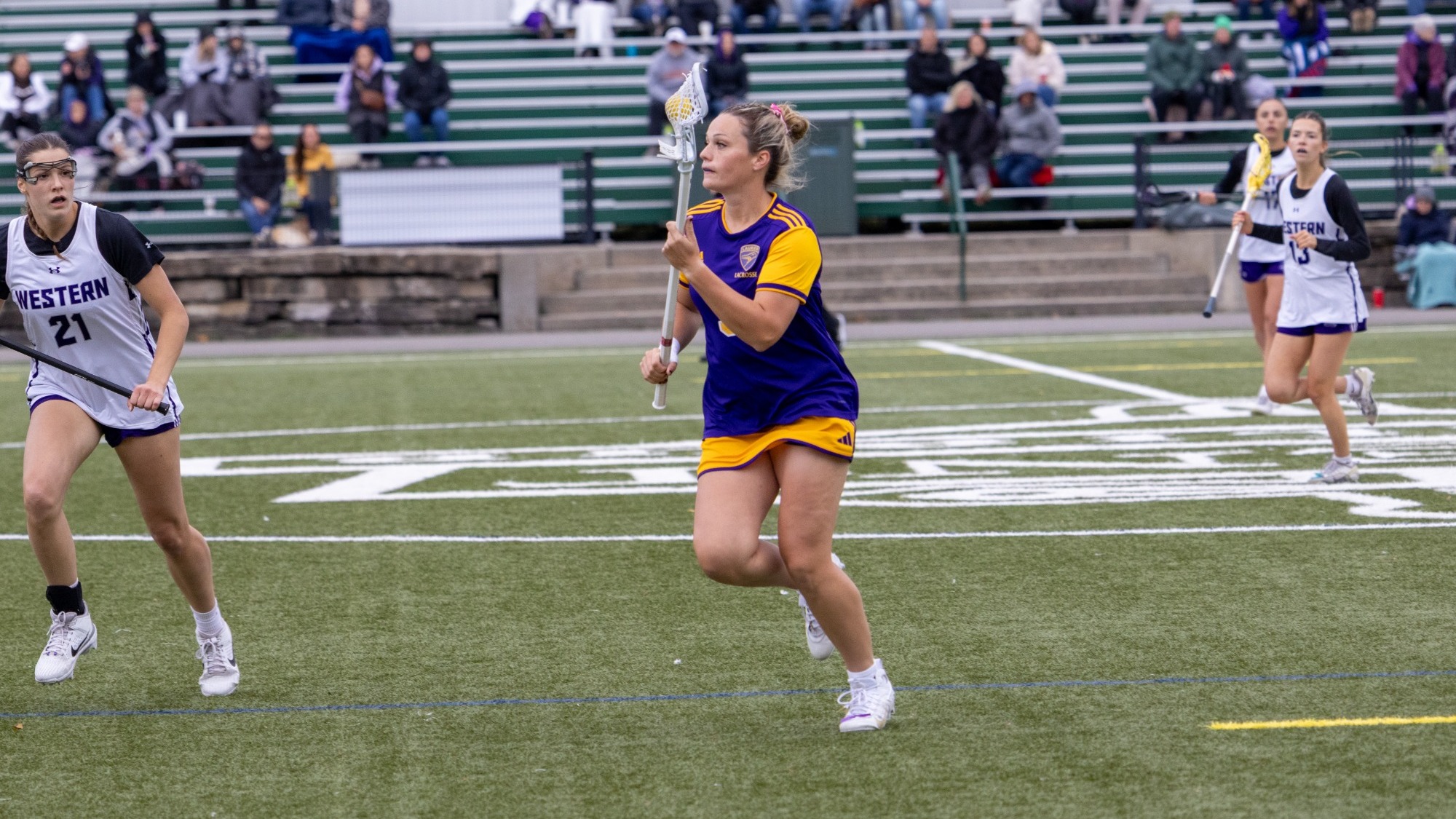 Kate Ferguson moves the ball forward for Laurier lacrosse.