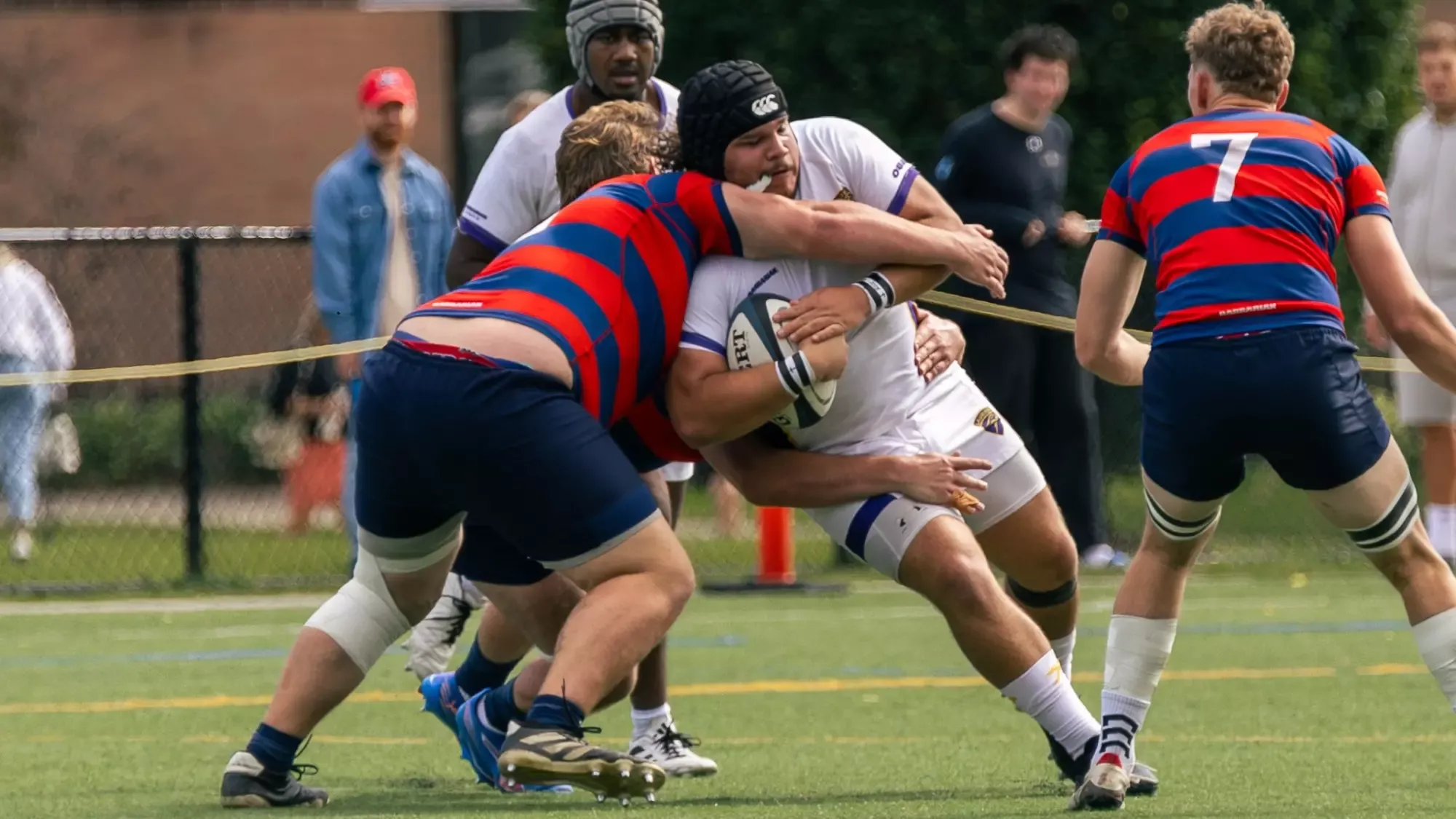 Laurier men's rugby carry the ball against Brock