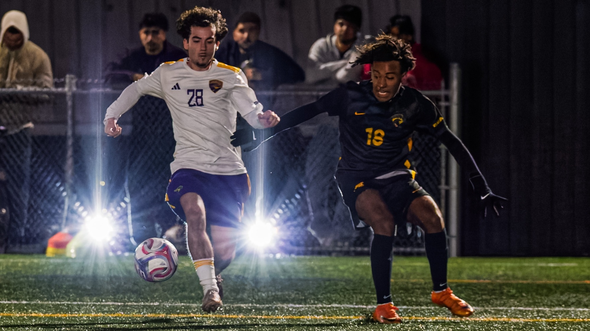 Laurier and Waterloo soccer players go after the ball