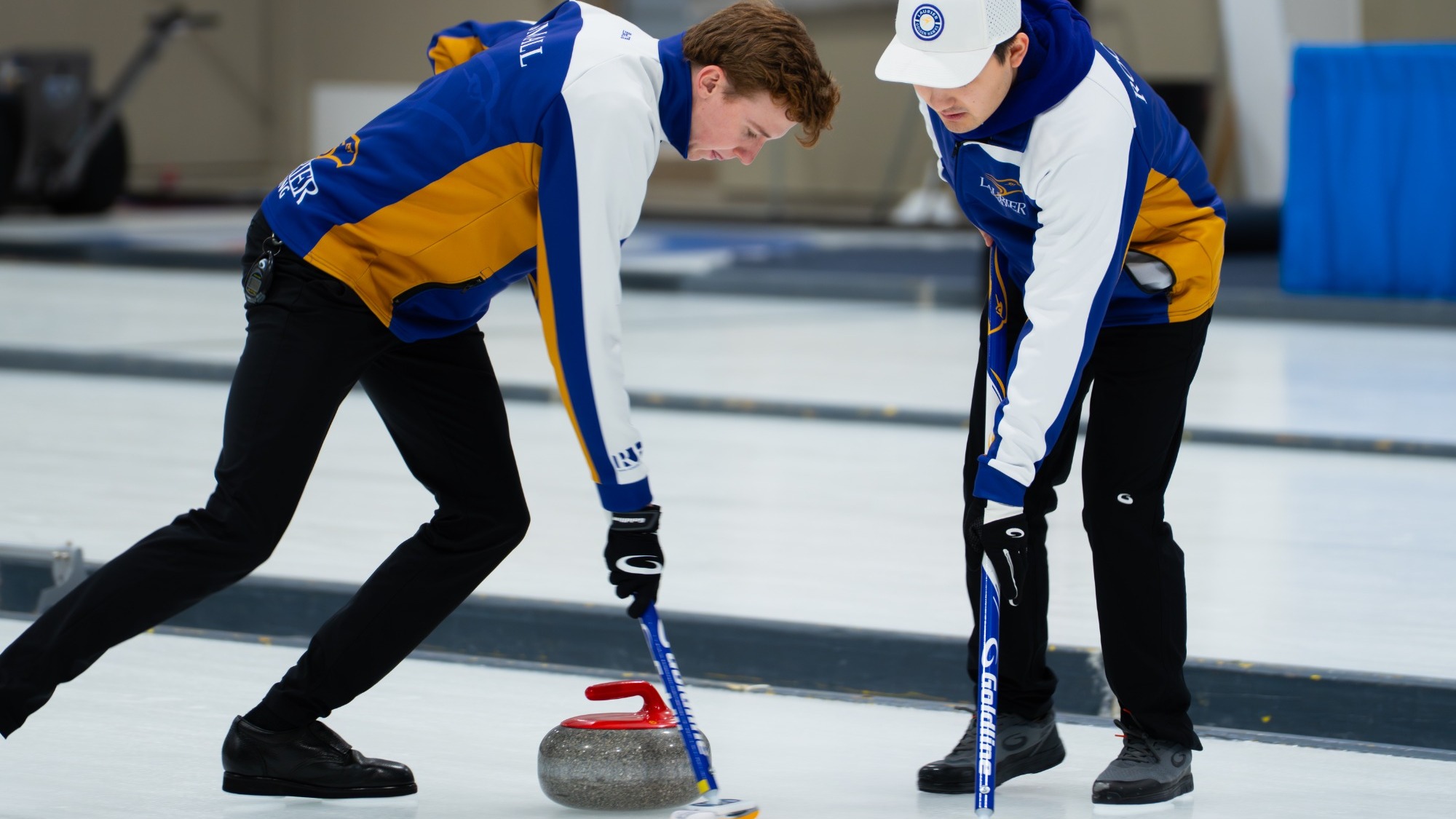 Wyatt Small and Landan Rooney sweep a stone at nationals.