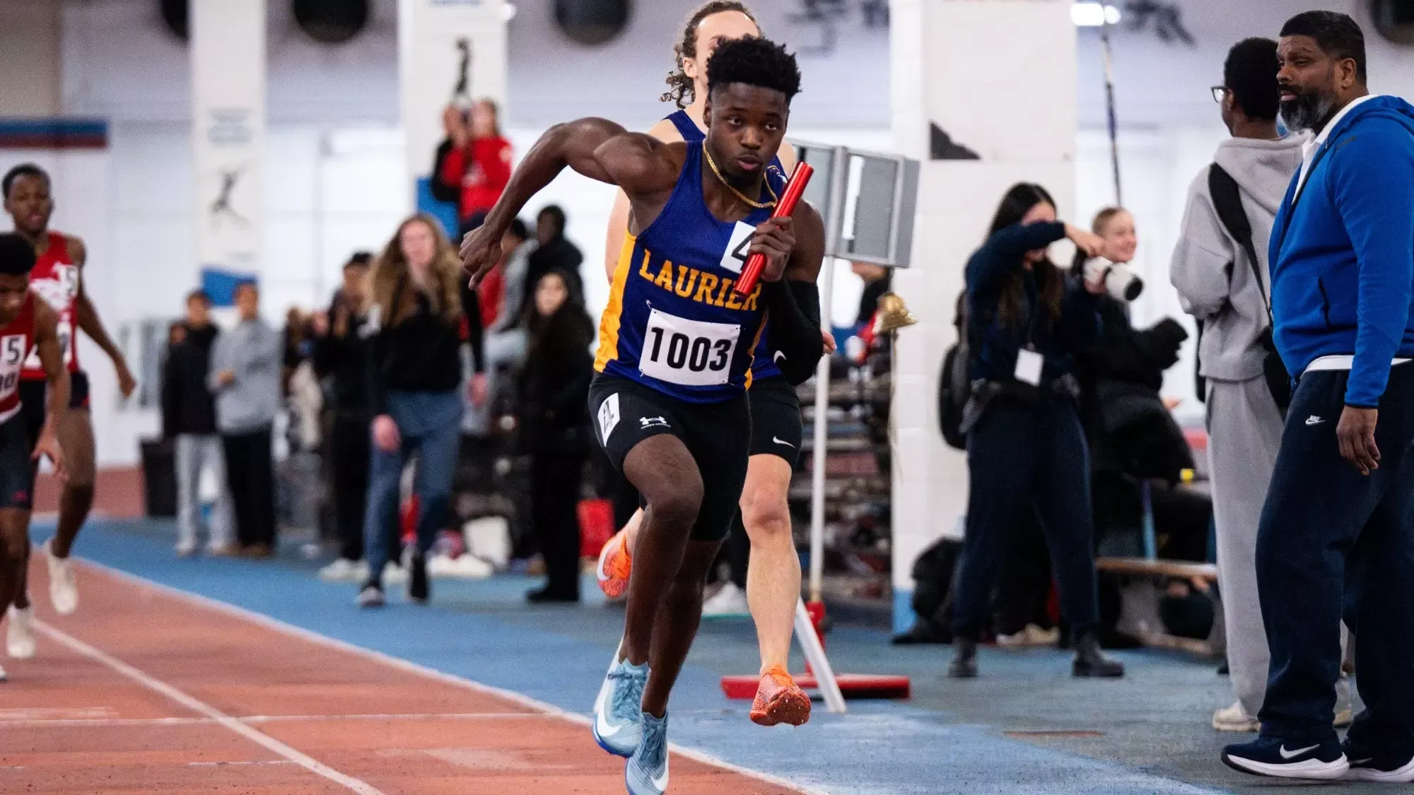 Laurier men's track relay team races at York.