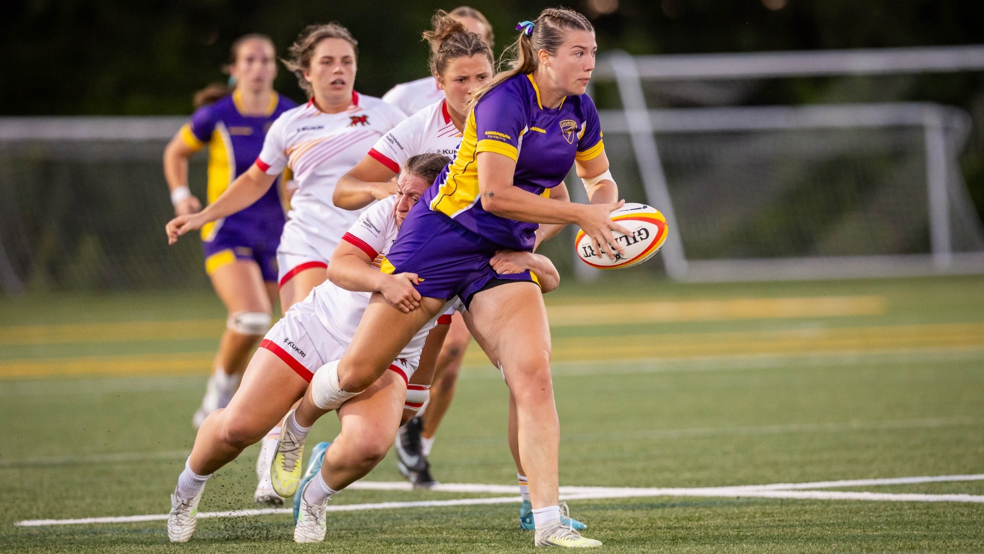 Laurier women's rugby tries to break loose from a Guelph tackler.