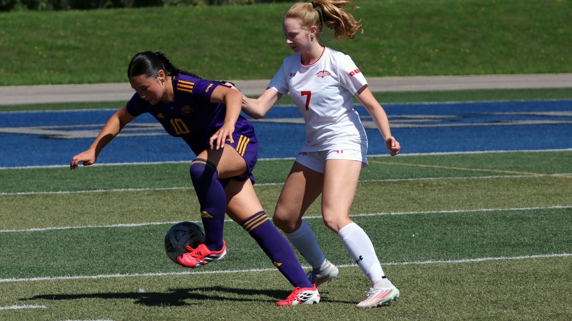 Laurier fends off an  Algoma defender