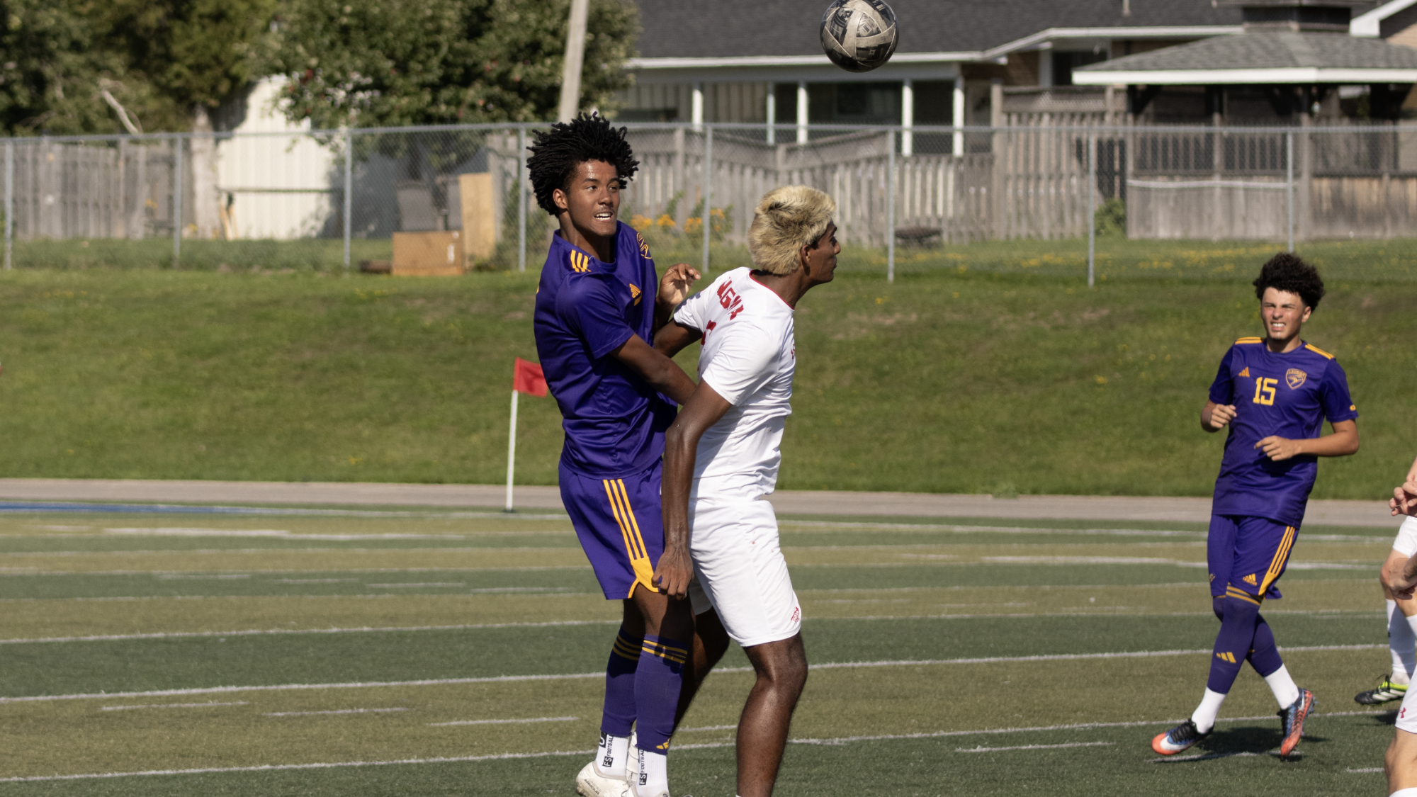 Laurier challenges for a header at Algoma