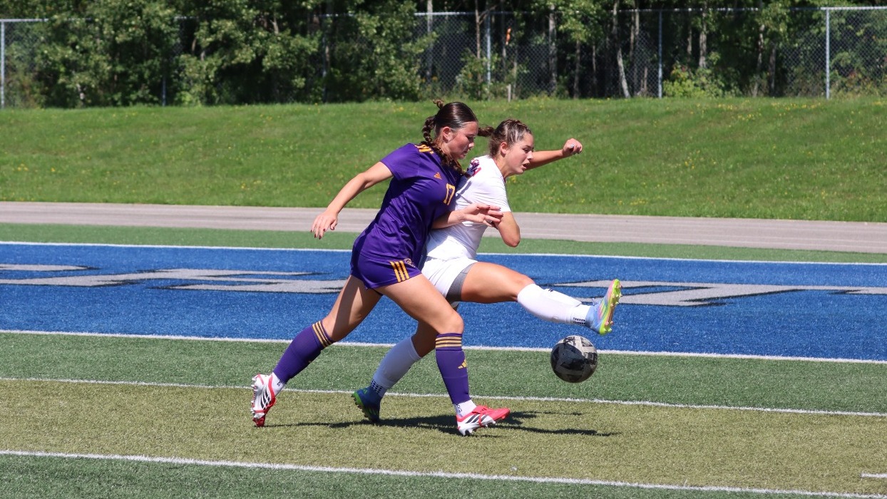 Laurier puts pressure on an Algoma defender.