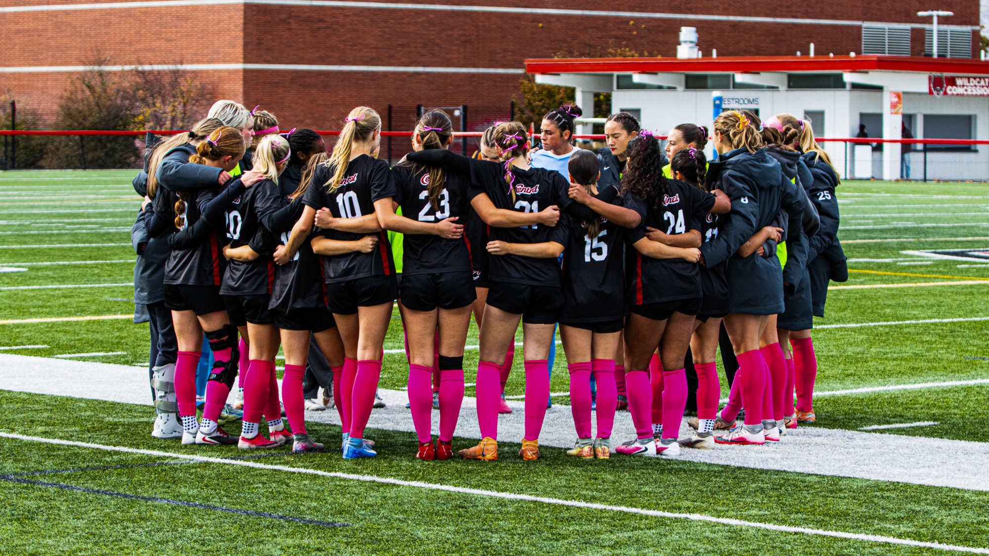 Wildcats huddled up before their pink out match against MSUB.