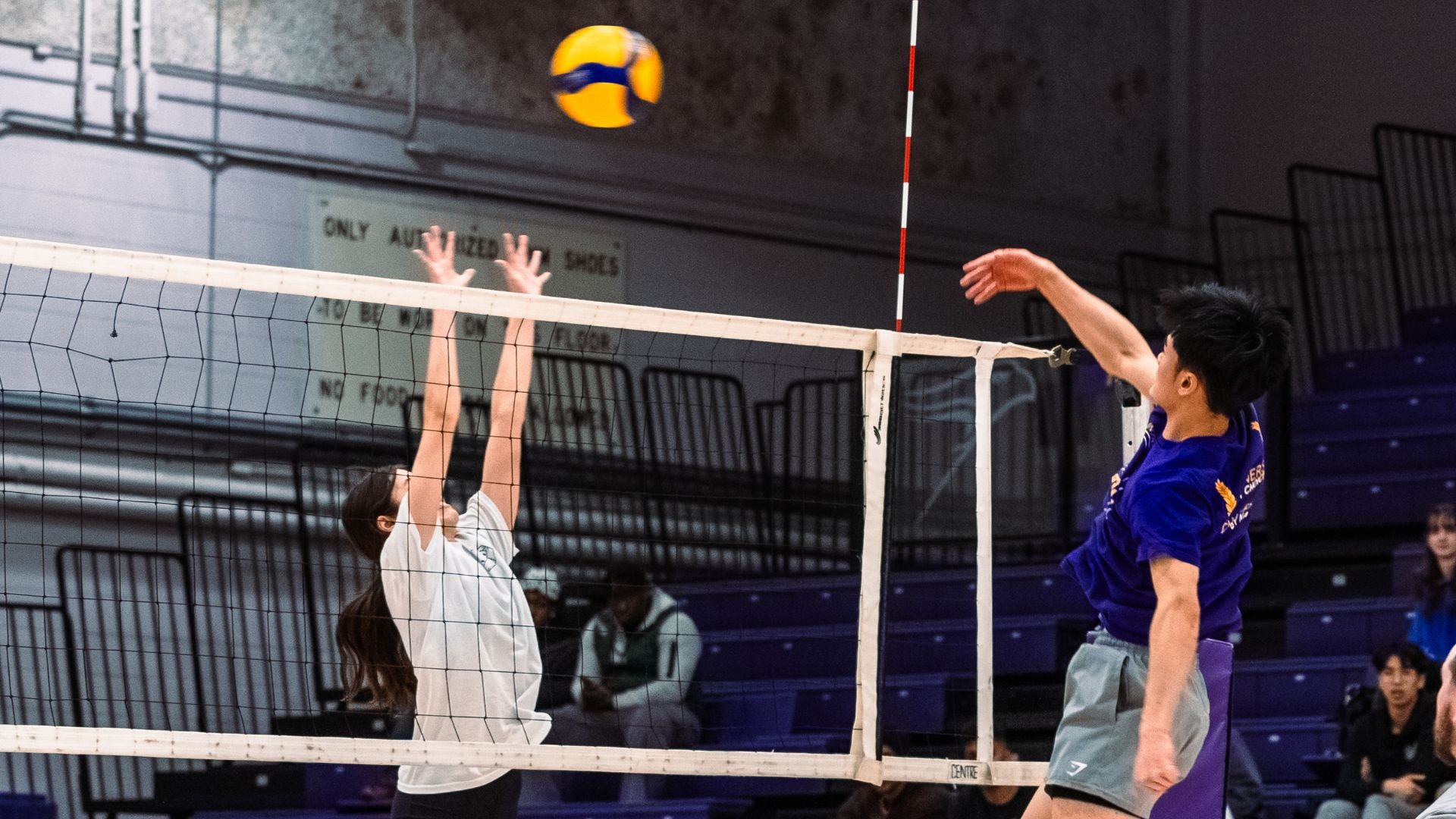 Two athletes compete in a volleyball match during the Winter 2024 Intramural All-Star Game