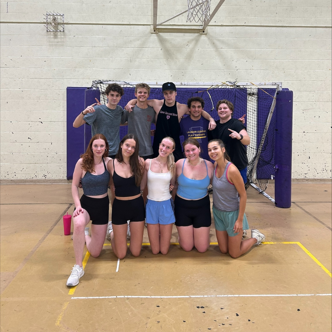 The Domino's Intramural Team of the Week from the European Handball league poses in front of the basketball net