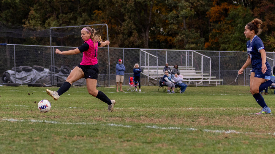 Halley Shaffer kicks the ball with her right foot after beating a defender