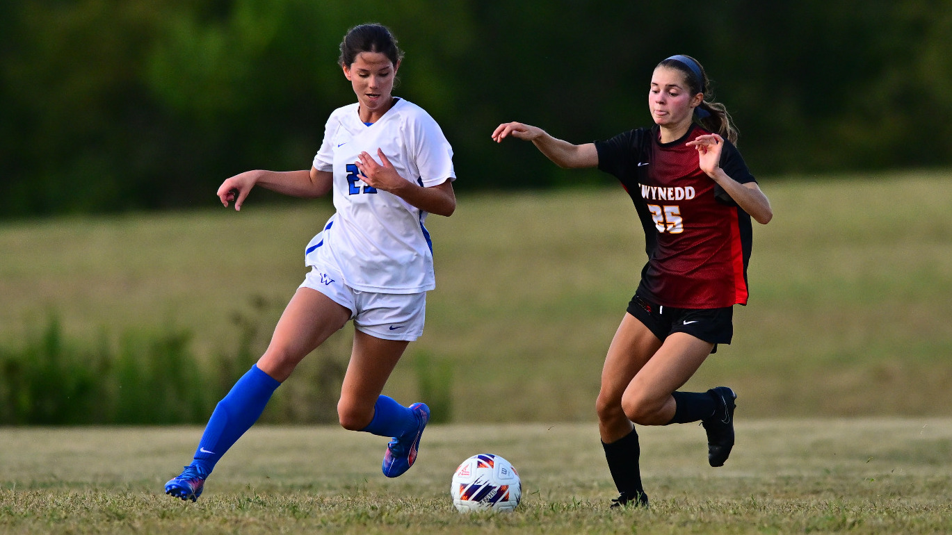 Savanna Mackie dribbles the ball by an opponent.