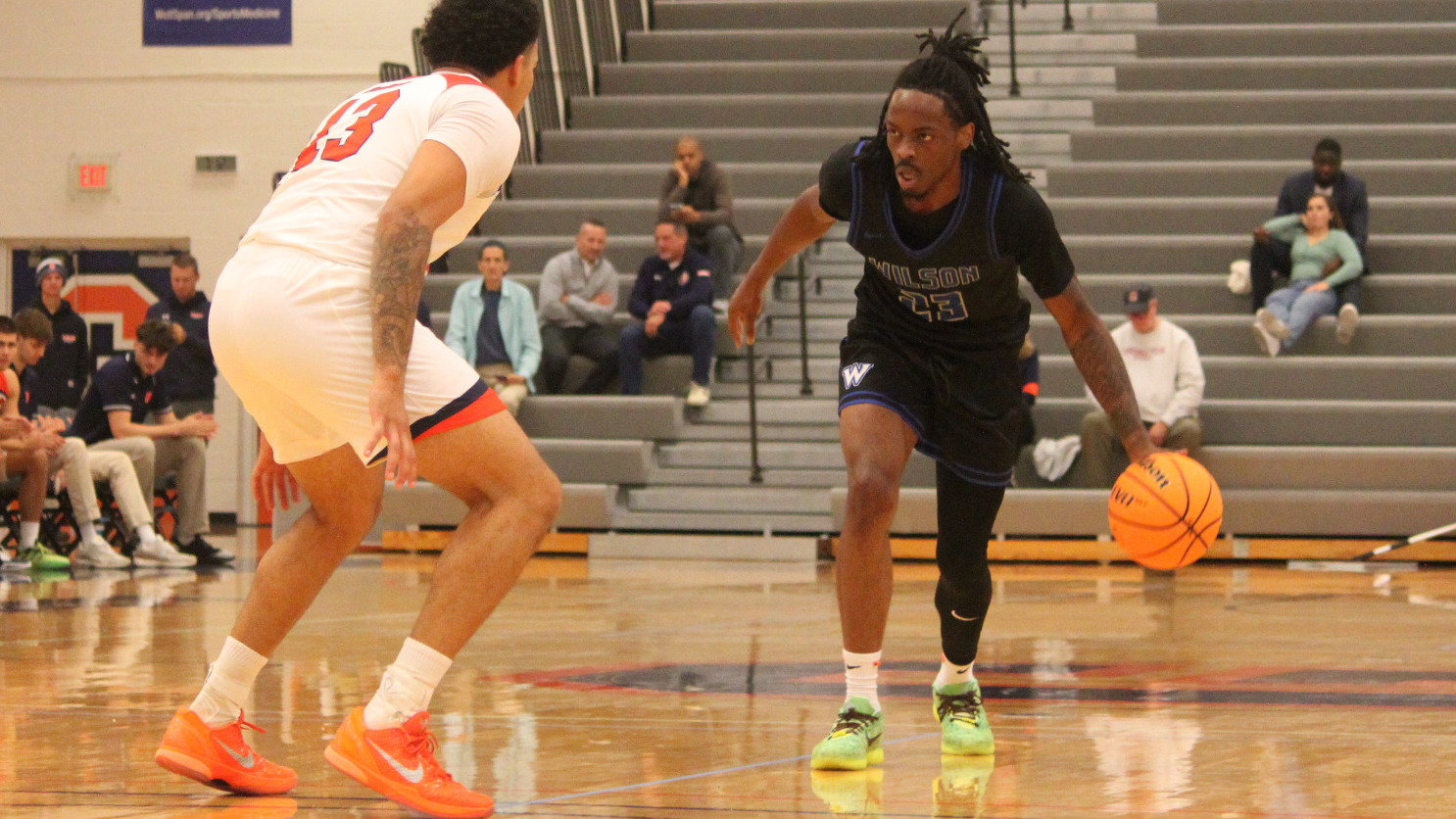 Armani Jones starts driving to the basket while being guarded by a defender