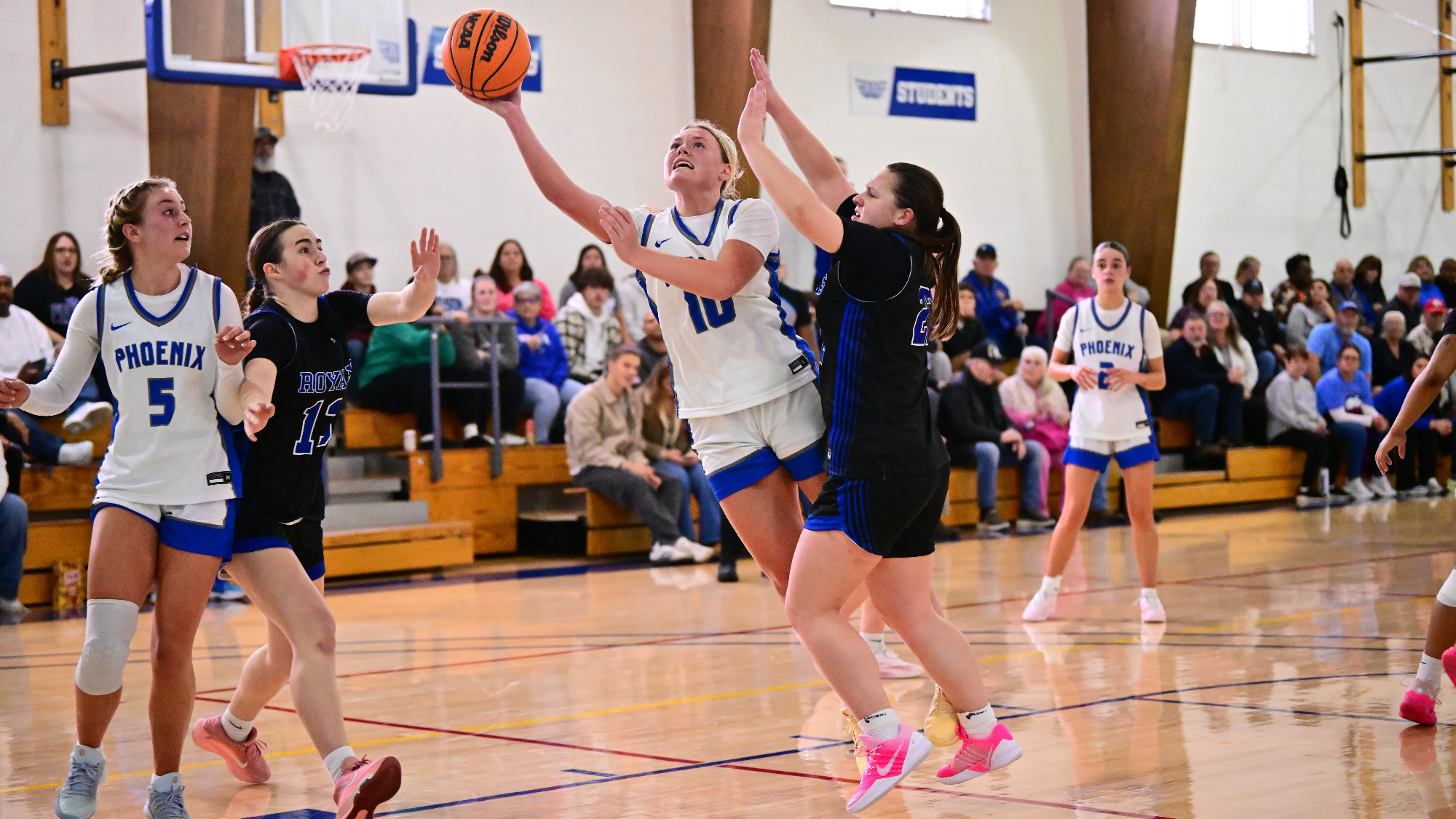 Chelcie Forrester goes in for a layup while being defended on the right block.