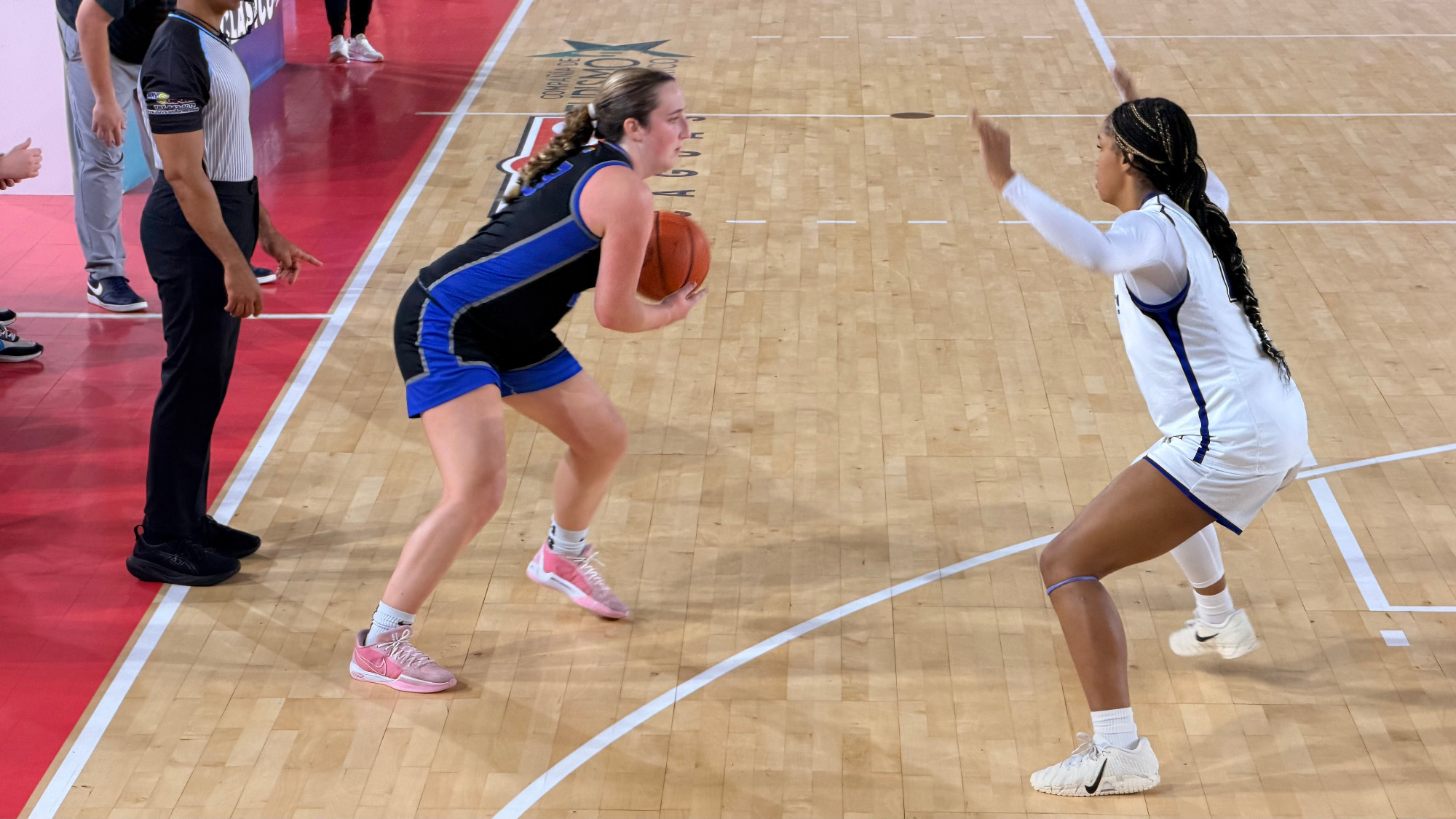 Mackenzie Caldwell-Degnon pump fakes for a 3-pointer against a Marymount defender.
