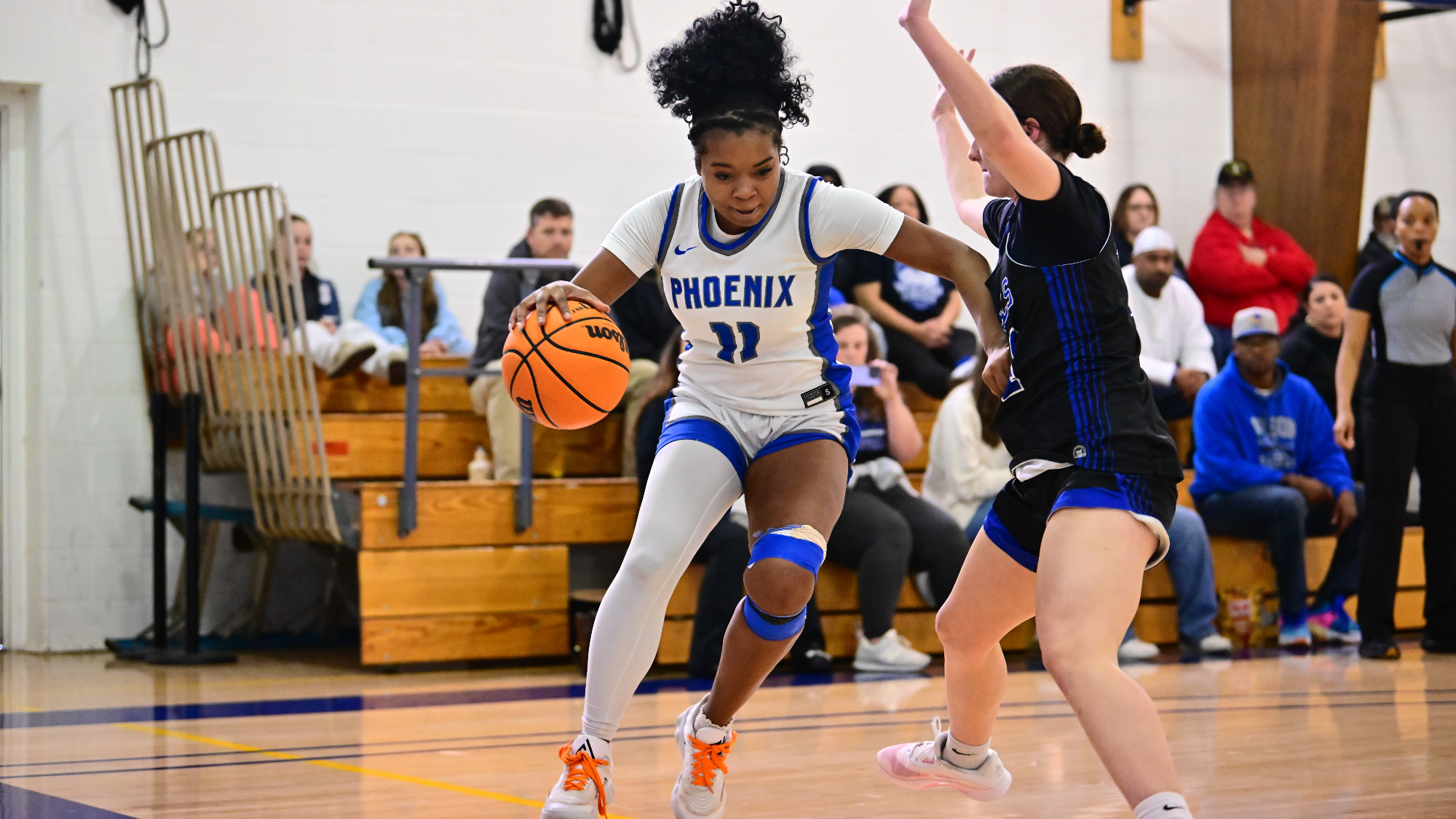 Lae Black drives the base line guarded by an opposing player.