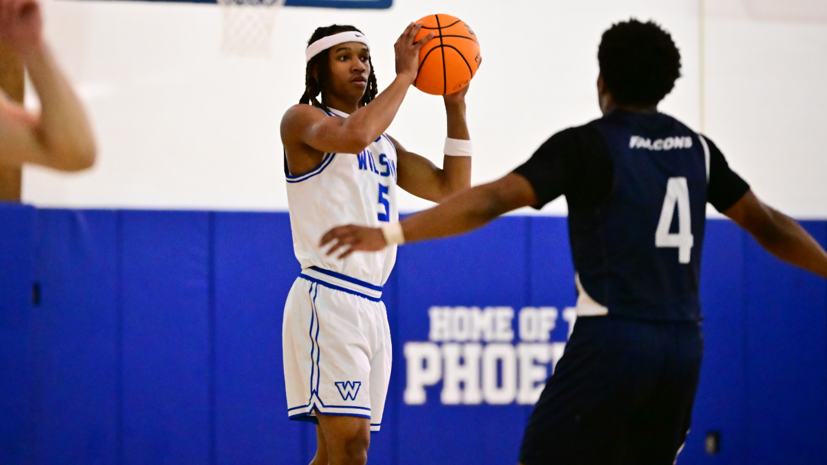 Jalen Bowie looks to make a pass to an open player.
