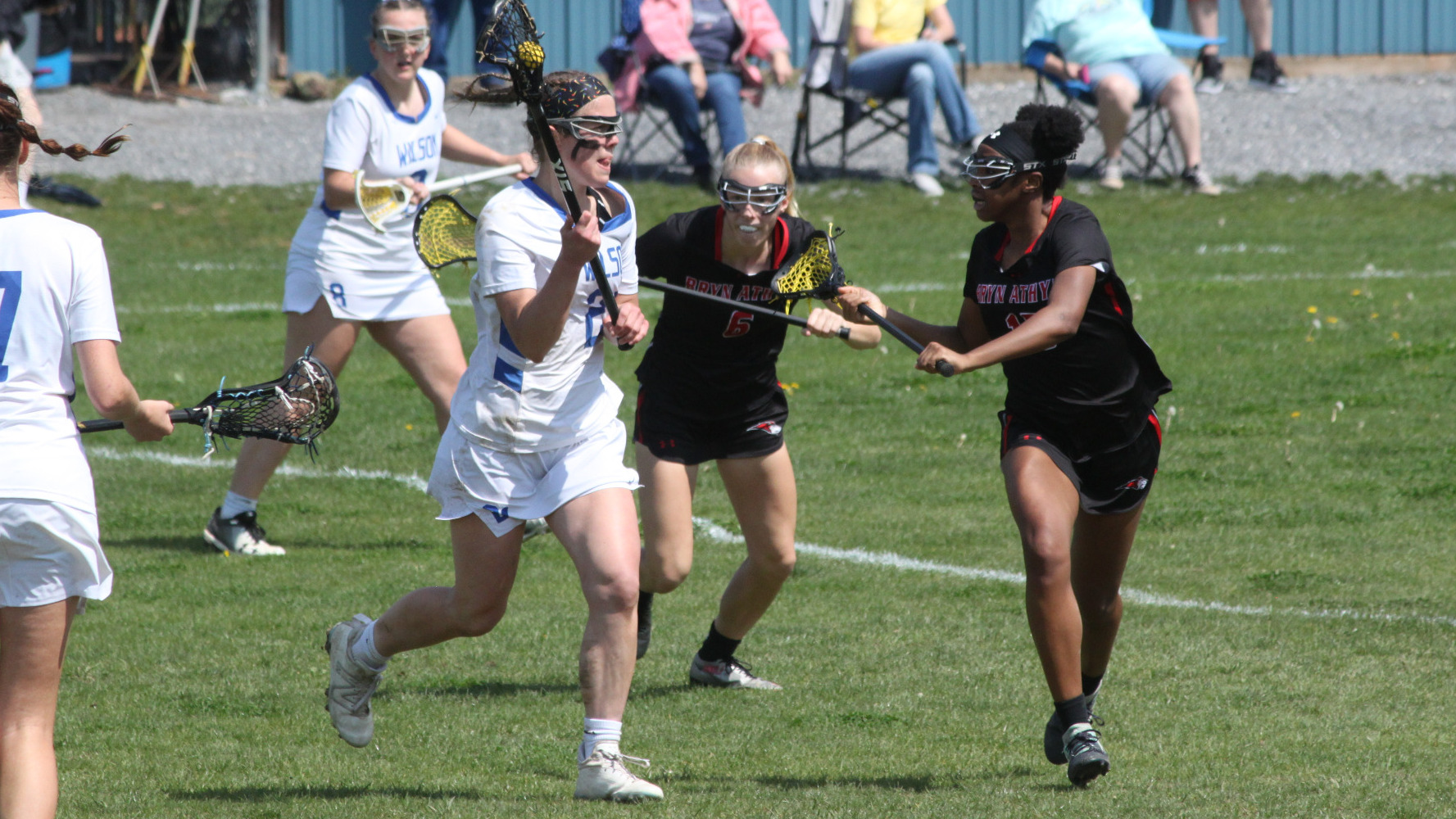 Sage Lague drives into the offensive zone guarded by two Bryn Athyn defenders