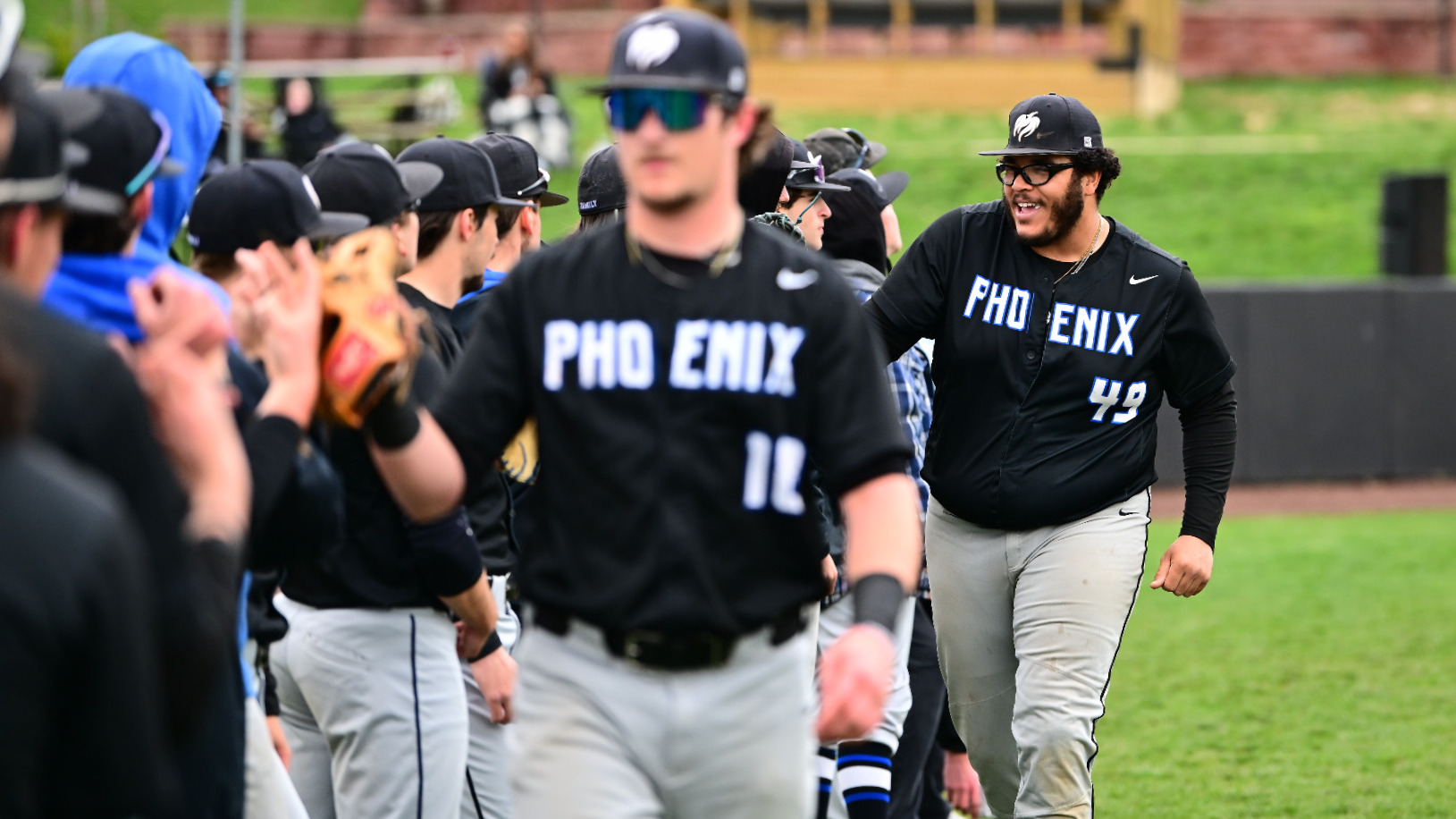 Harry Middlebrooks and Jordan Daphney get fist bumps from the rest of the team.