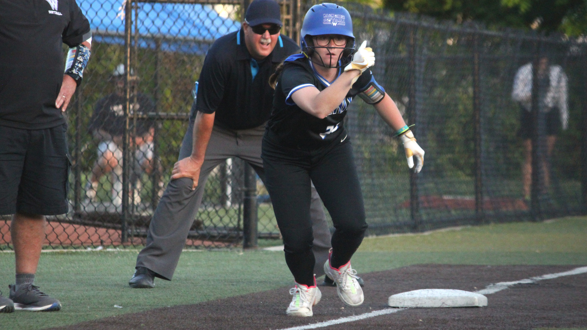 Caitlin Oliviero takes a few steps off third base after the pitch.