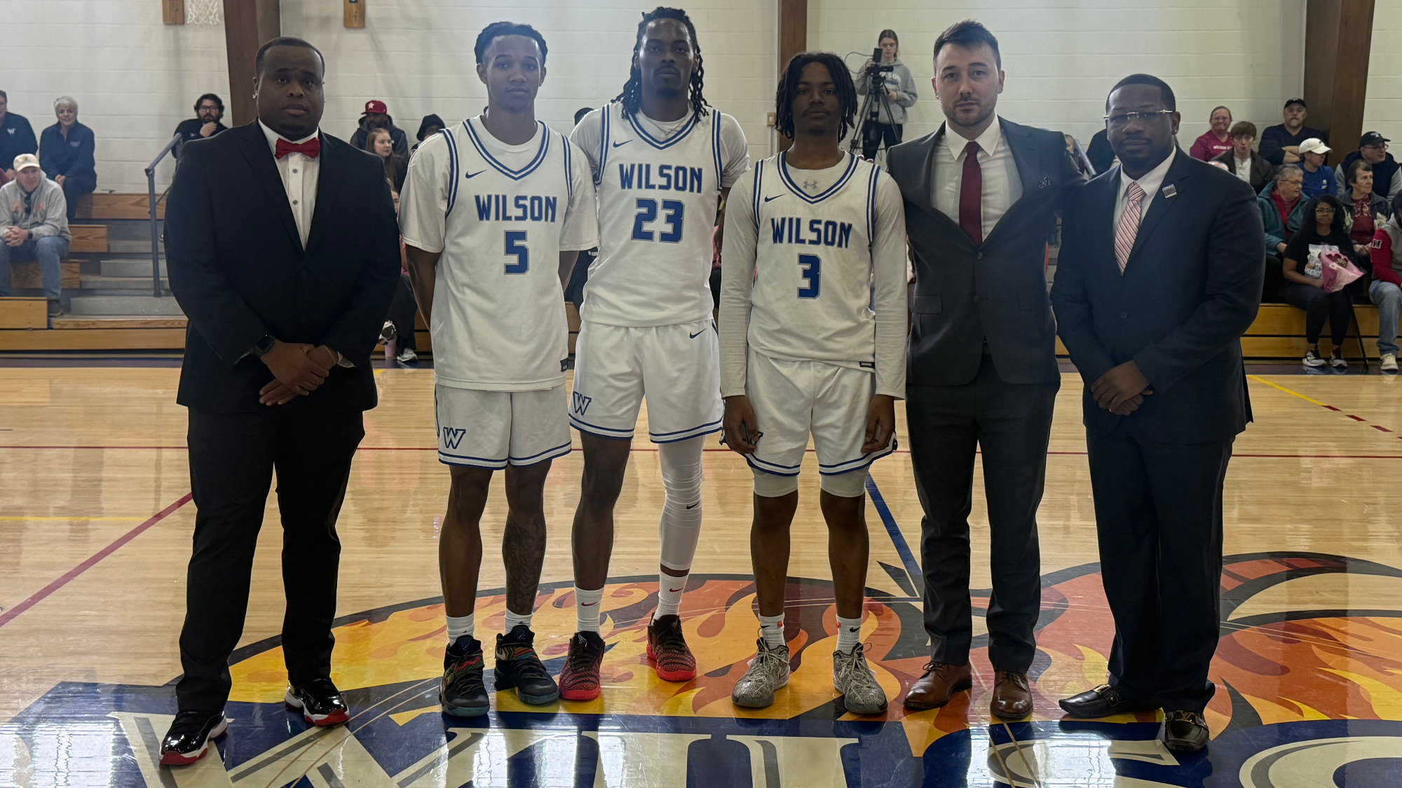 Coaches and Seniors Pose For a Pictures at Midcourt