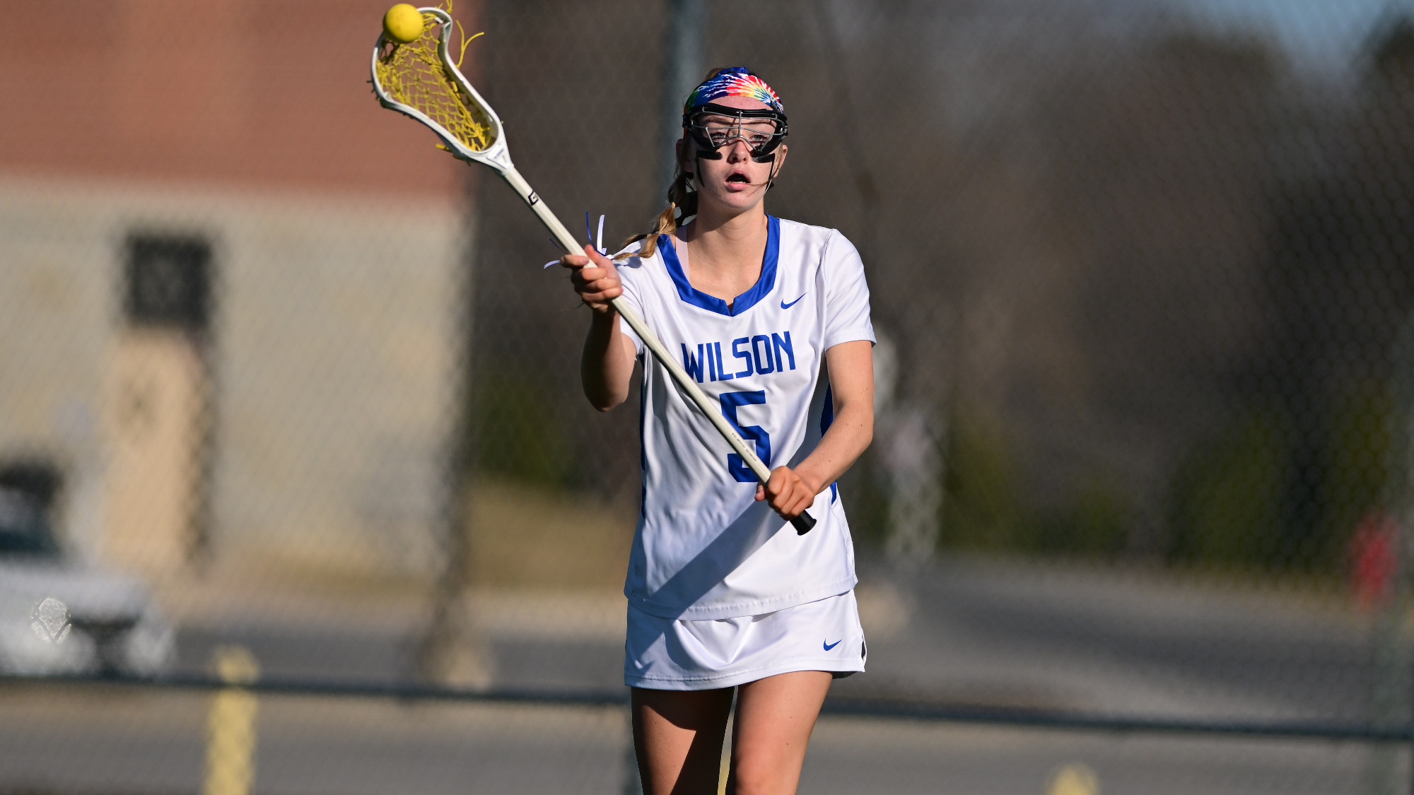 Sadie Fike throws the ball with her stick