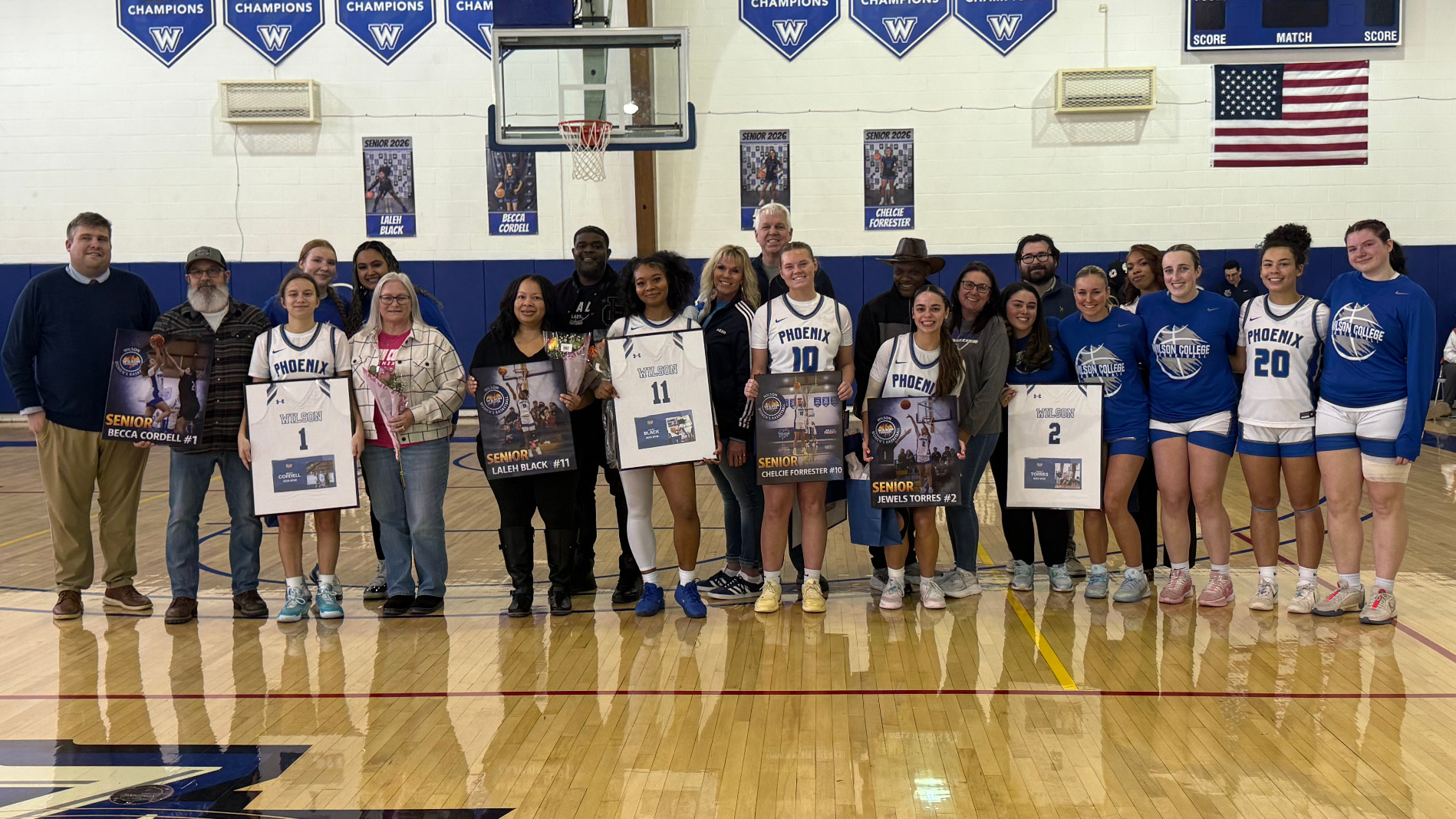 Seniors pose with the team and family