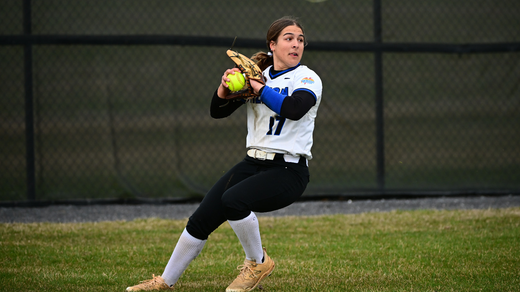 Addison Woods throws the ball in from left field