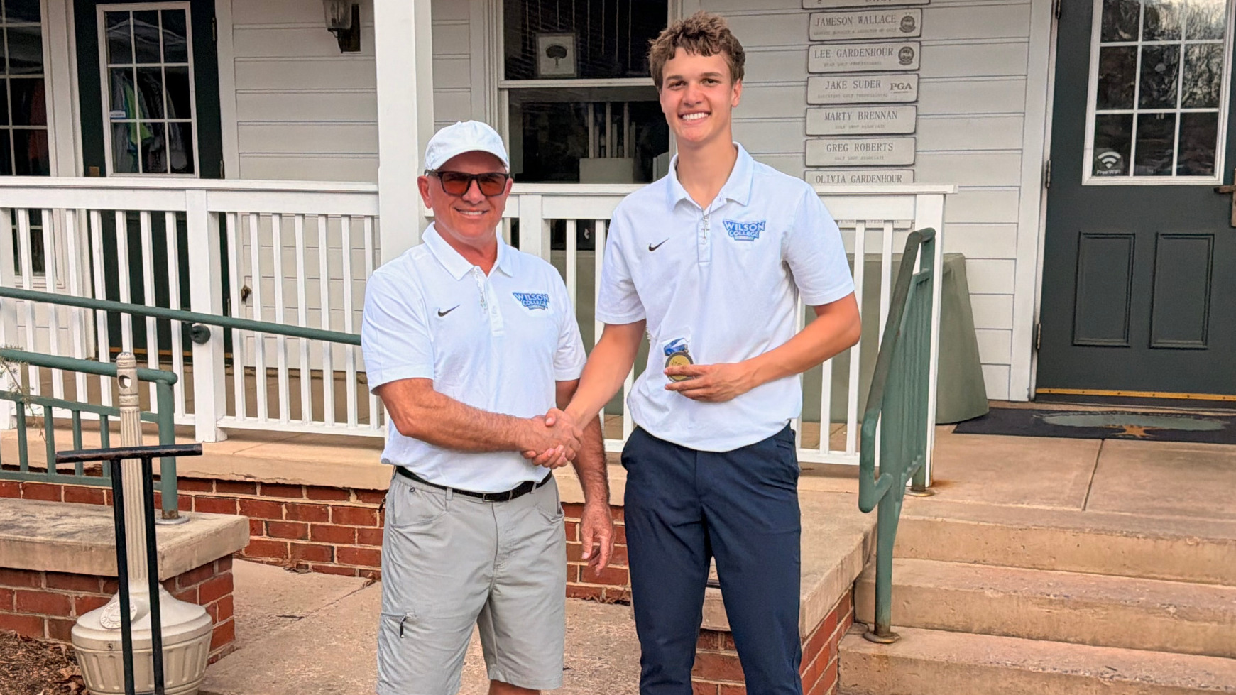 Head Coach Tony Yaniello presents Cole Cooper with the medalist award