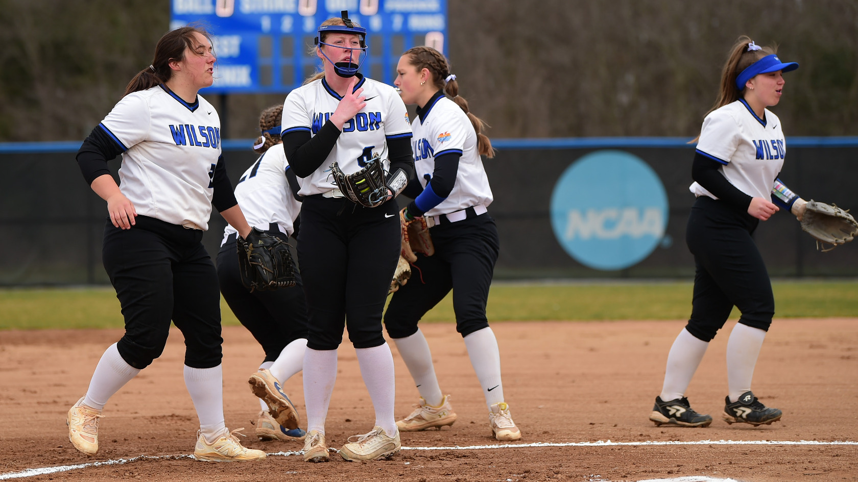 Infield meets int he circle before the game gets started.
