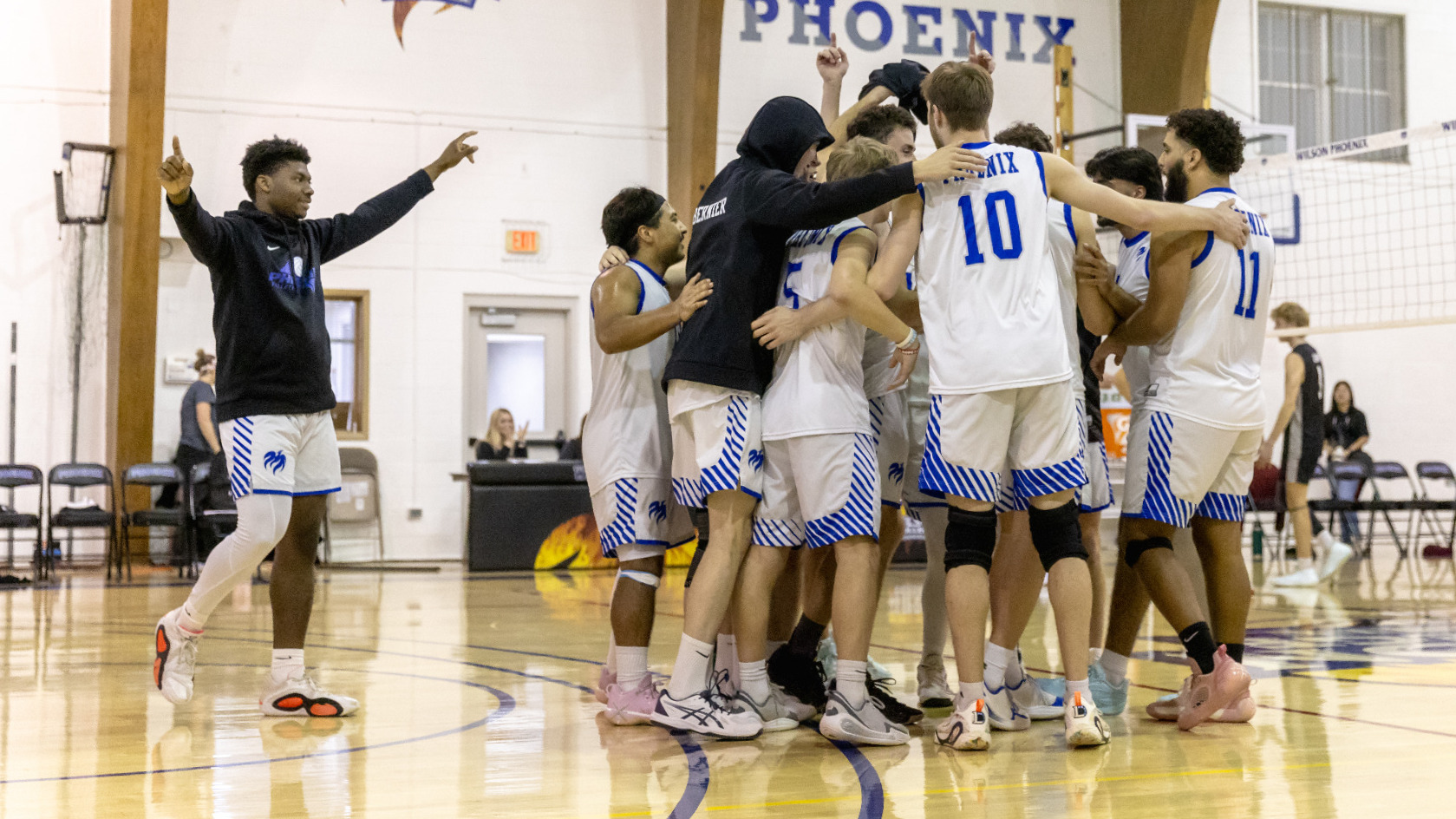 The men's volleyball team celebrates after its semifinal win