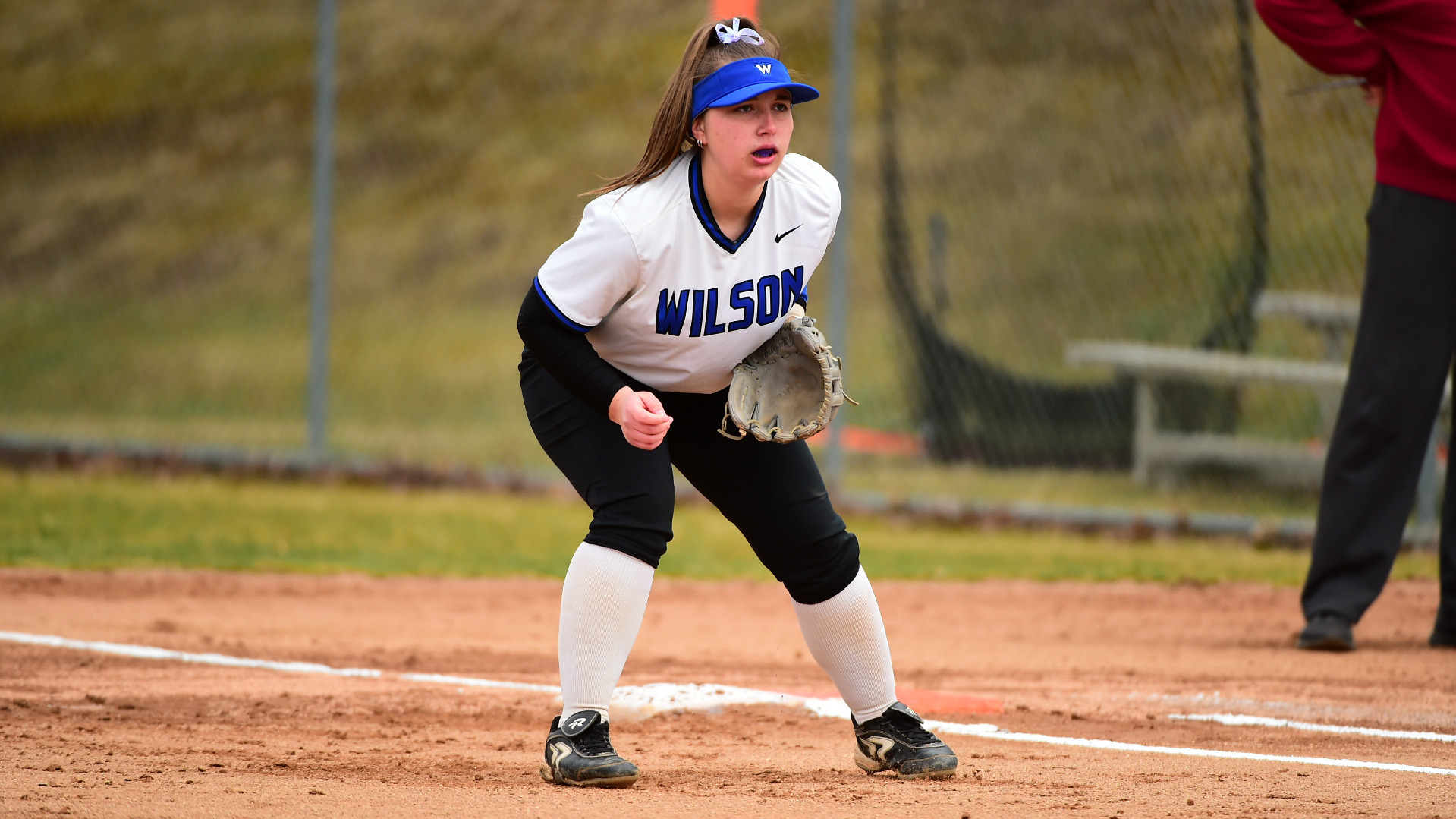 Sydney Hartle looks at the batter while standing near first base