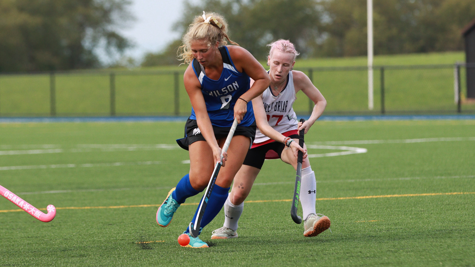 Greta Harkreader brings the ball by a defender