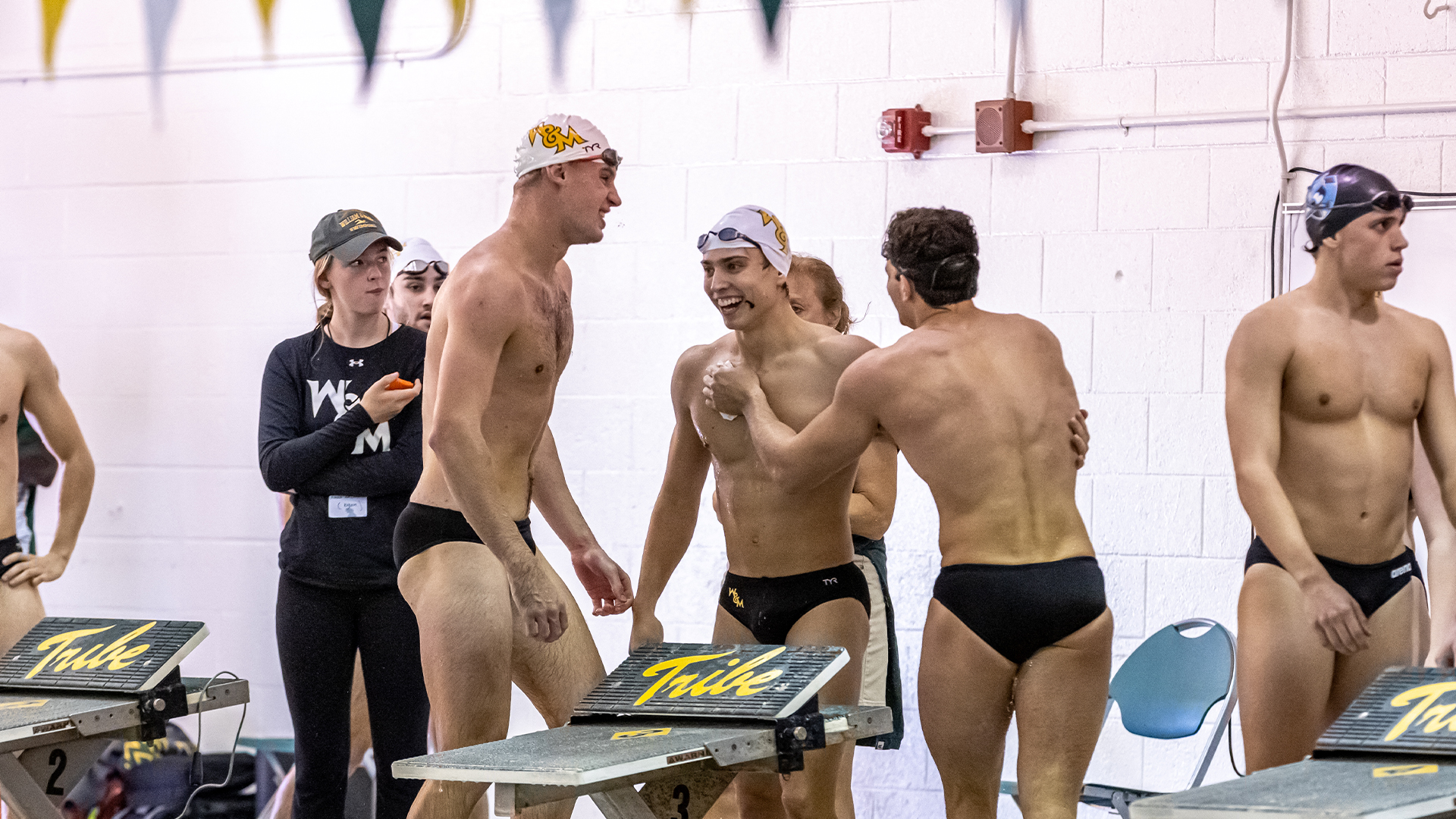 Swimming celebrates a relay win.