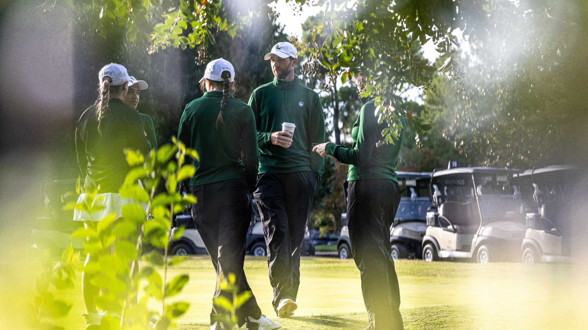 Women's Golf team talks before a round.