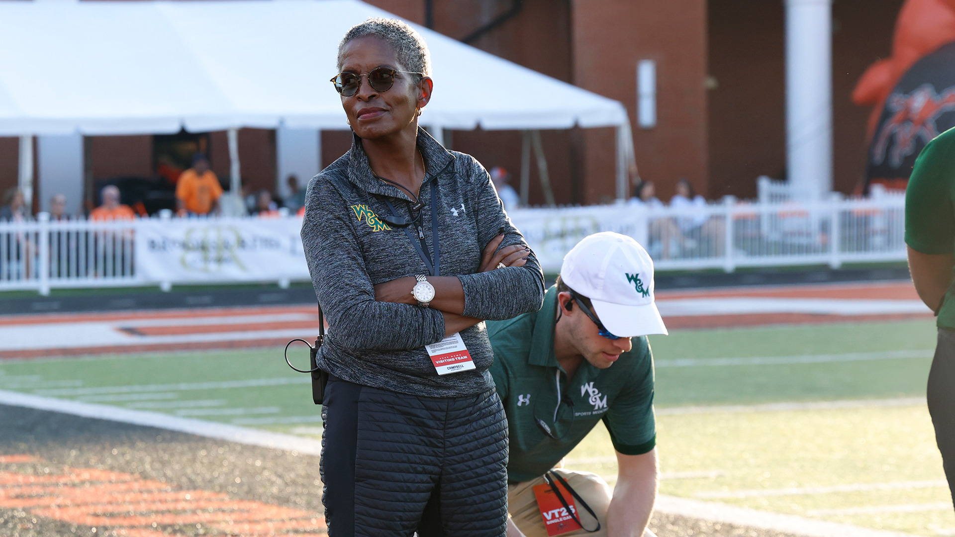 W&M's Chief Medical Officer Virginia Wells, M.D. stands on the field during warm-ups during Tribe football's game at Campbell. 