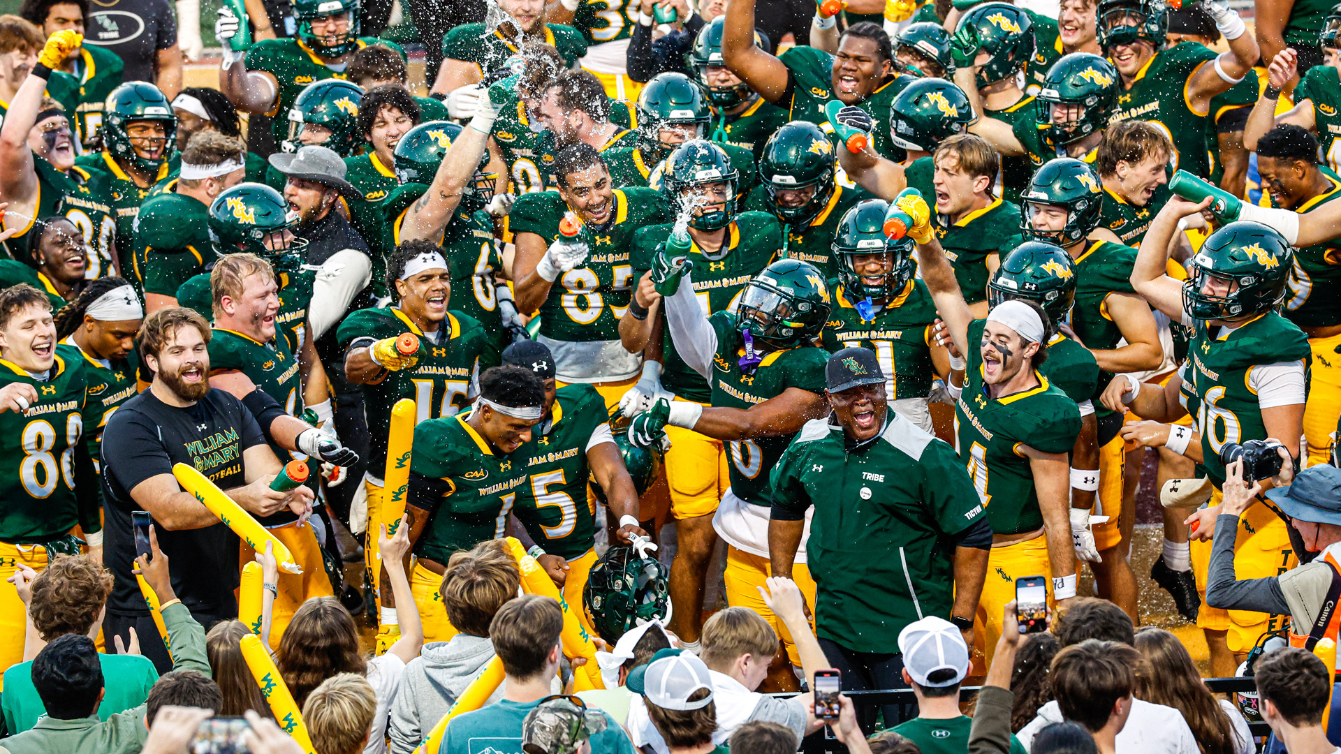 Members of the W&M football team celebrate a win at Zable Stadium