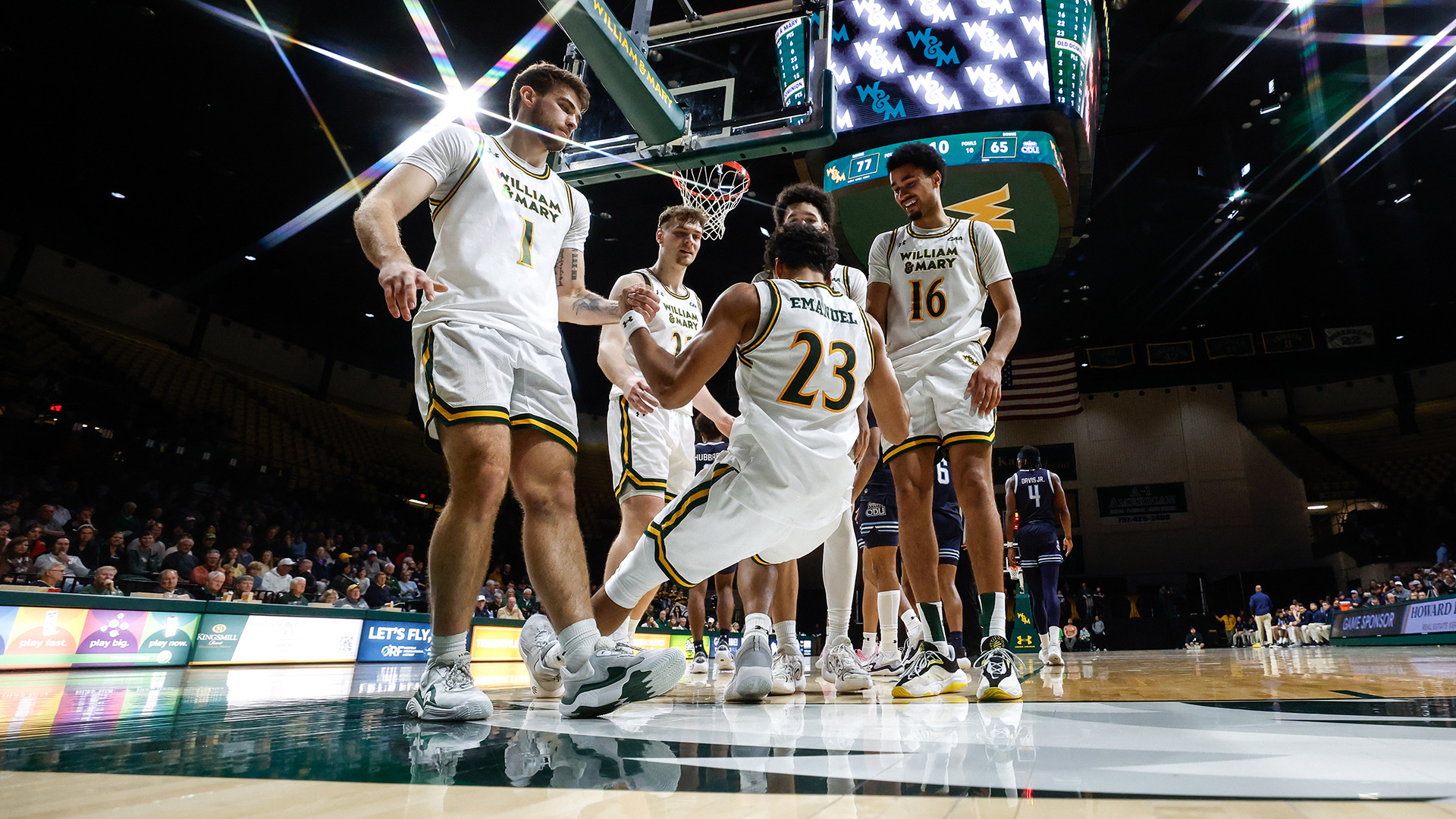 Cade Haskins, Ryan Jackson Jr., and Tunde Vahlberg Fasasi help Jo'el Emanuel off the court after he was fouled with Kilian Brockhoff coming over to celebrate. 
