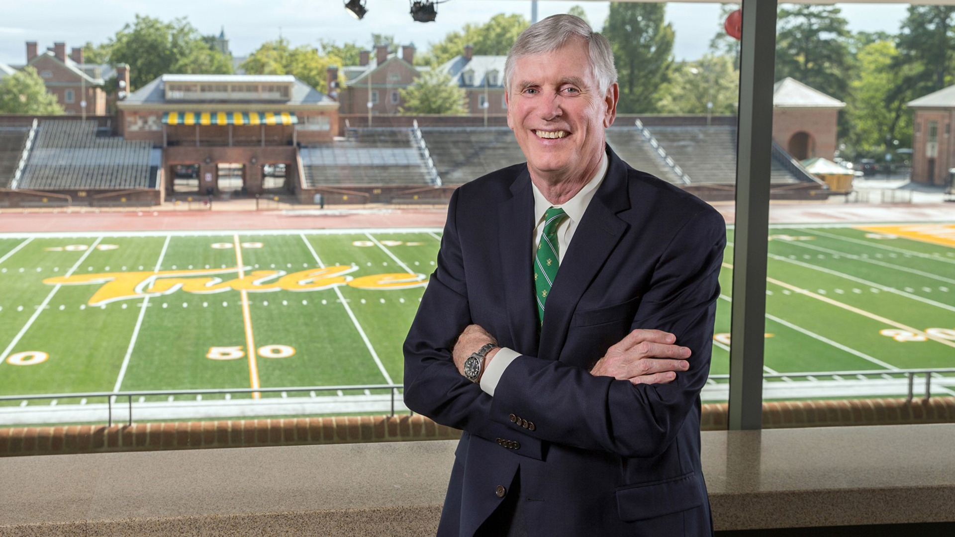 Former W&M Athletics Director Terry Driscoll stands in the suite area of Zable Stadium with the field in the background prior to his retirement from the school. 