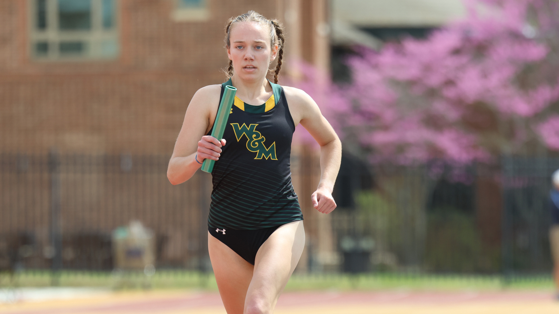Catherine Garrison runs with a baton on the track at Zable Stadium